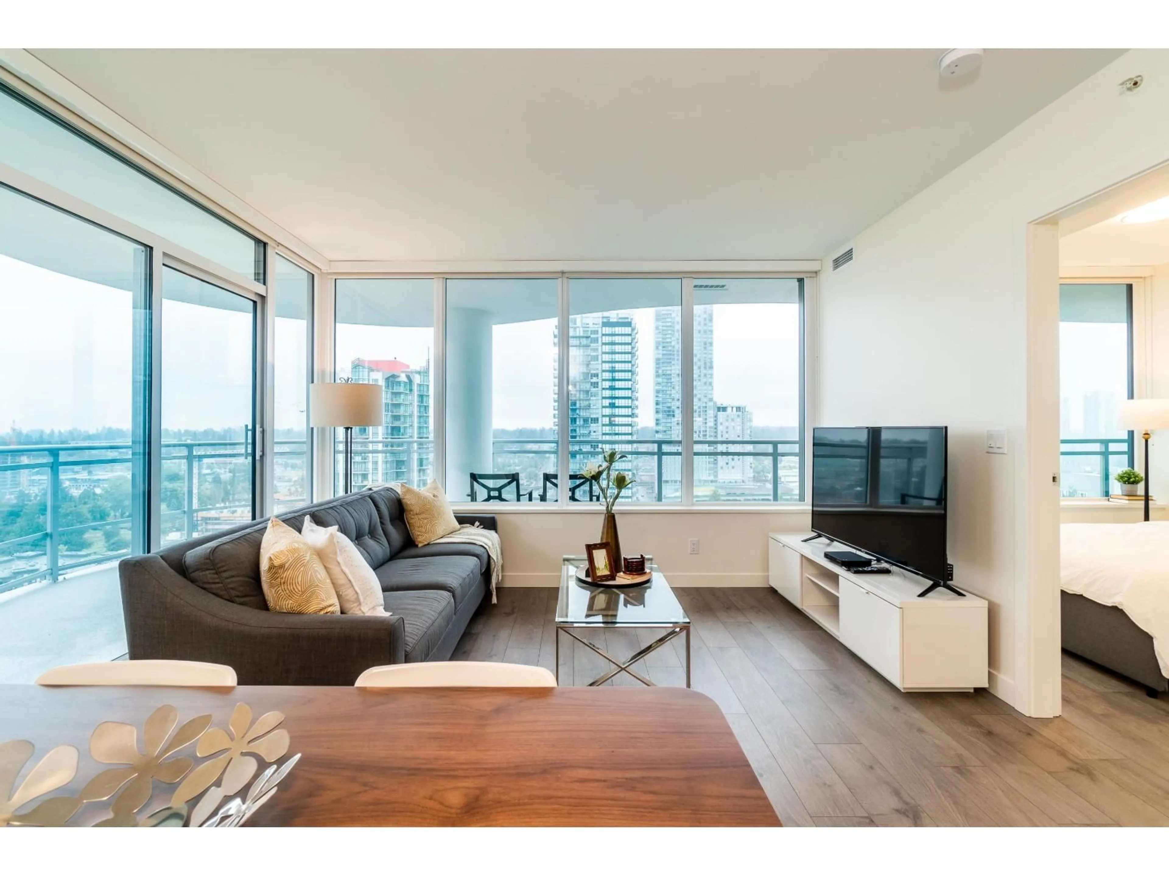 Living room with furniture, wood/laminate floor for 1703 - 13318 104 AVENUE, Surrey British Columbia V3T0R2