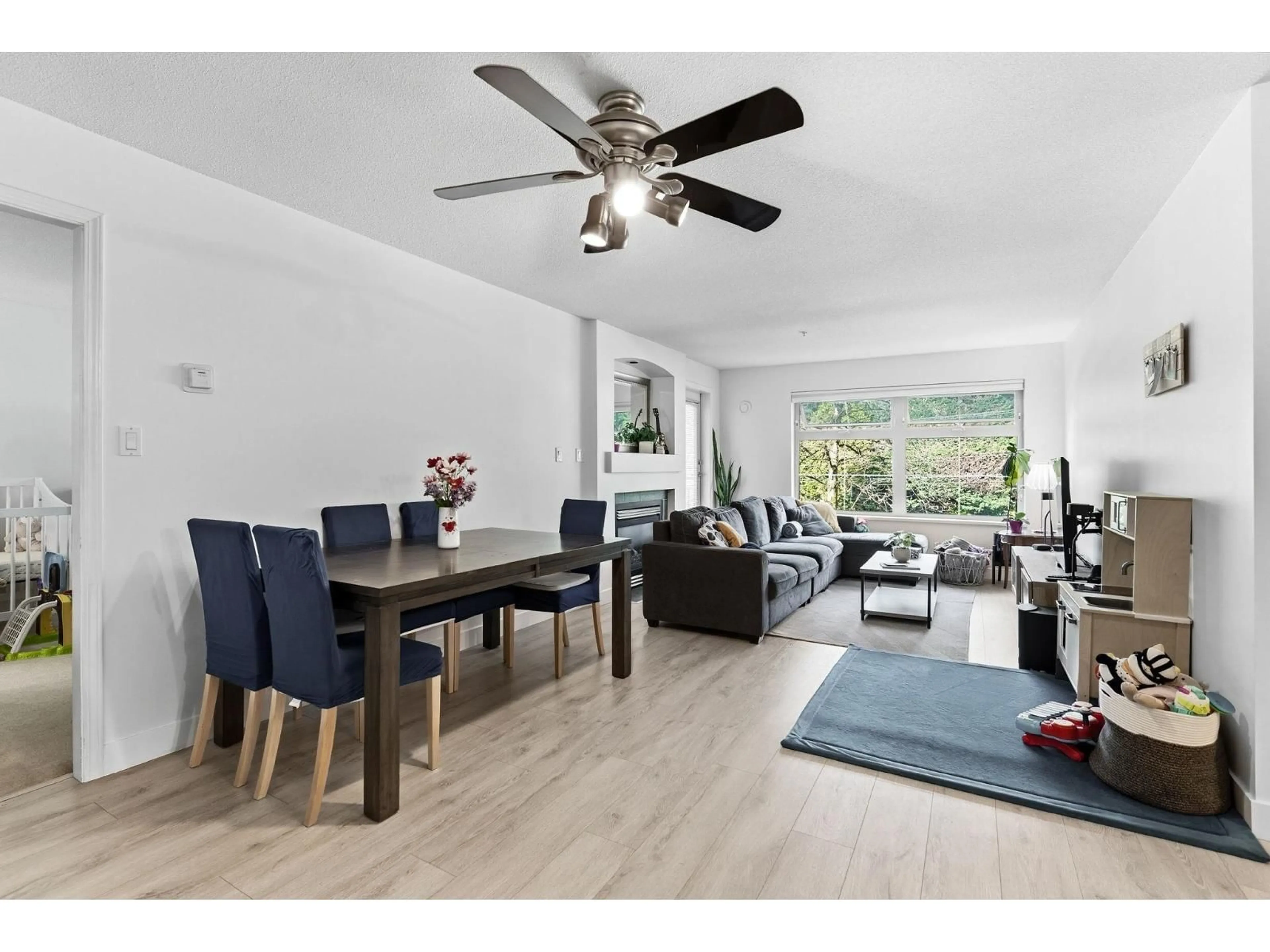 Living room with furniture, wood/laminate floor for 312 - 15220 GUILDFORD DRIVE, Surrey British Columbia V3R0Y6