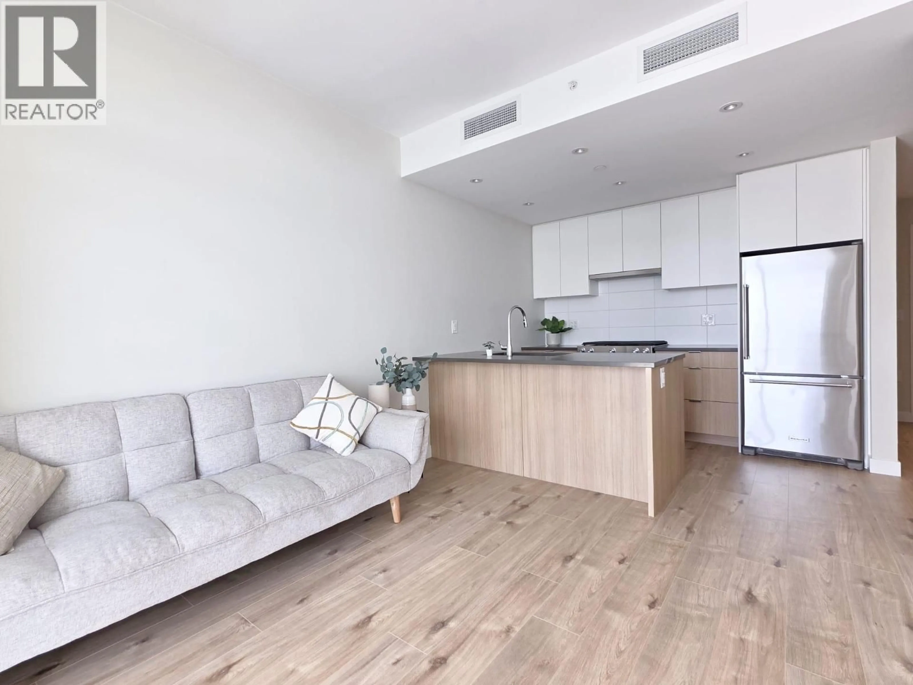 Living room with furniture, wood/laminate floor for 1503 - 3430 KENT AVENUE, Vancouver British Columbia V5S0G7