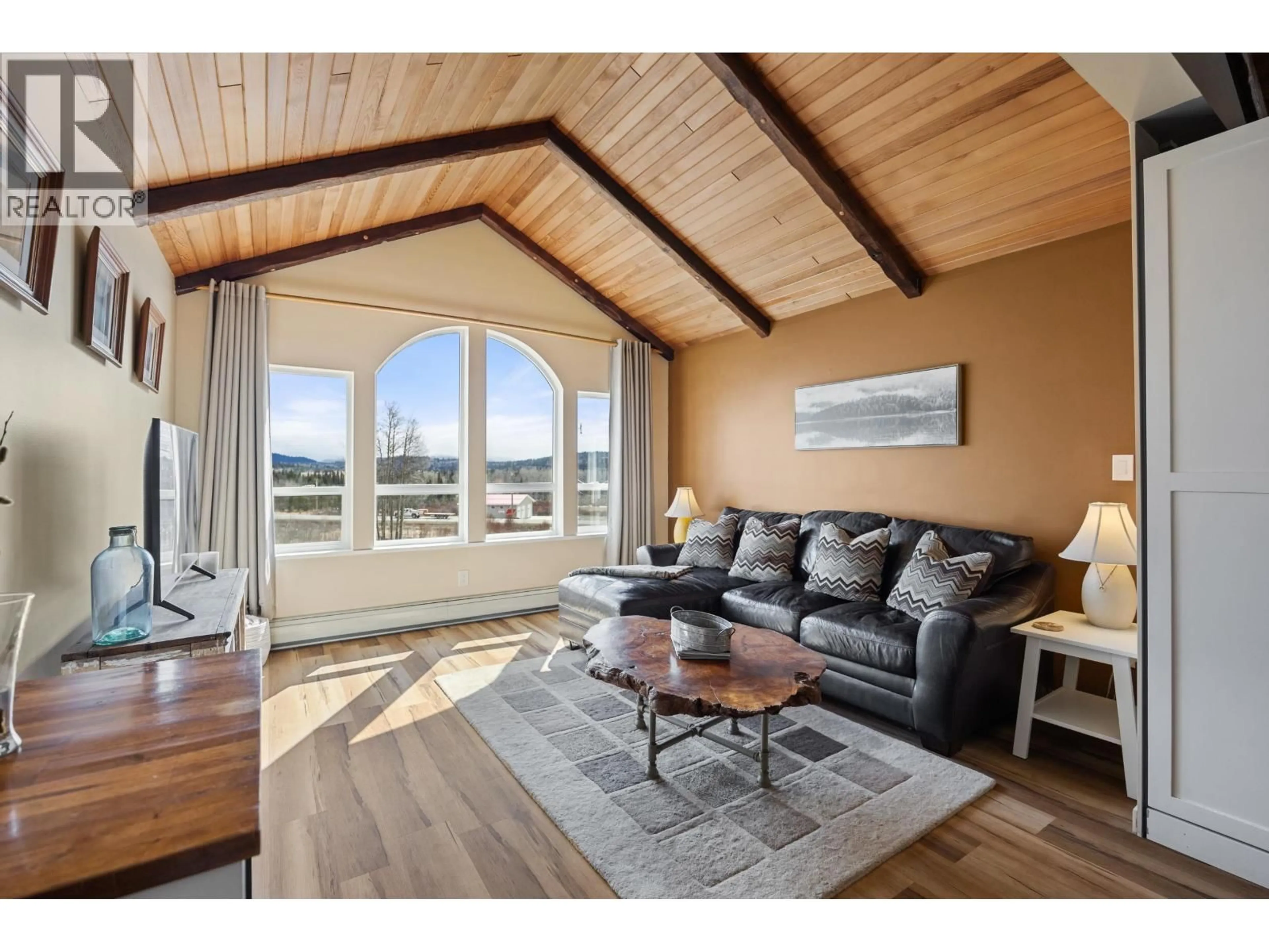 Living room with furniture, wood/laminate floor for 8261 LITTLE FORT 24 HIGHWAY, Bridge Lake British Columbia V0K1X2