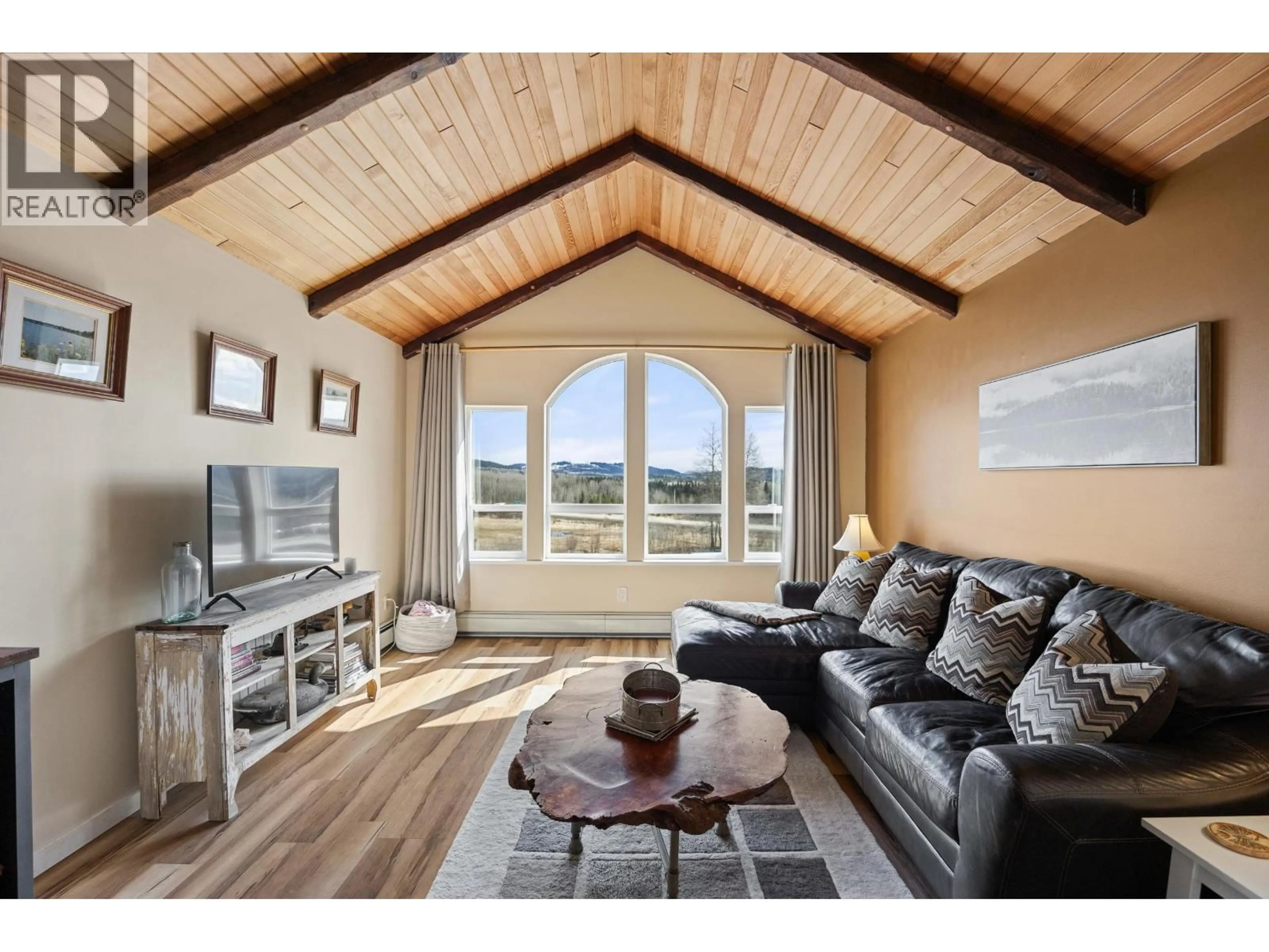 Living room with furniture, wood/laminate floor for 8261 LITTLE FORT 24 HIGHWAY, Bridge Lake British Columbia V0K1X2