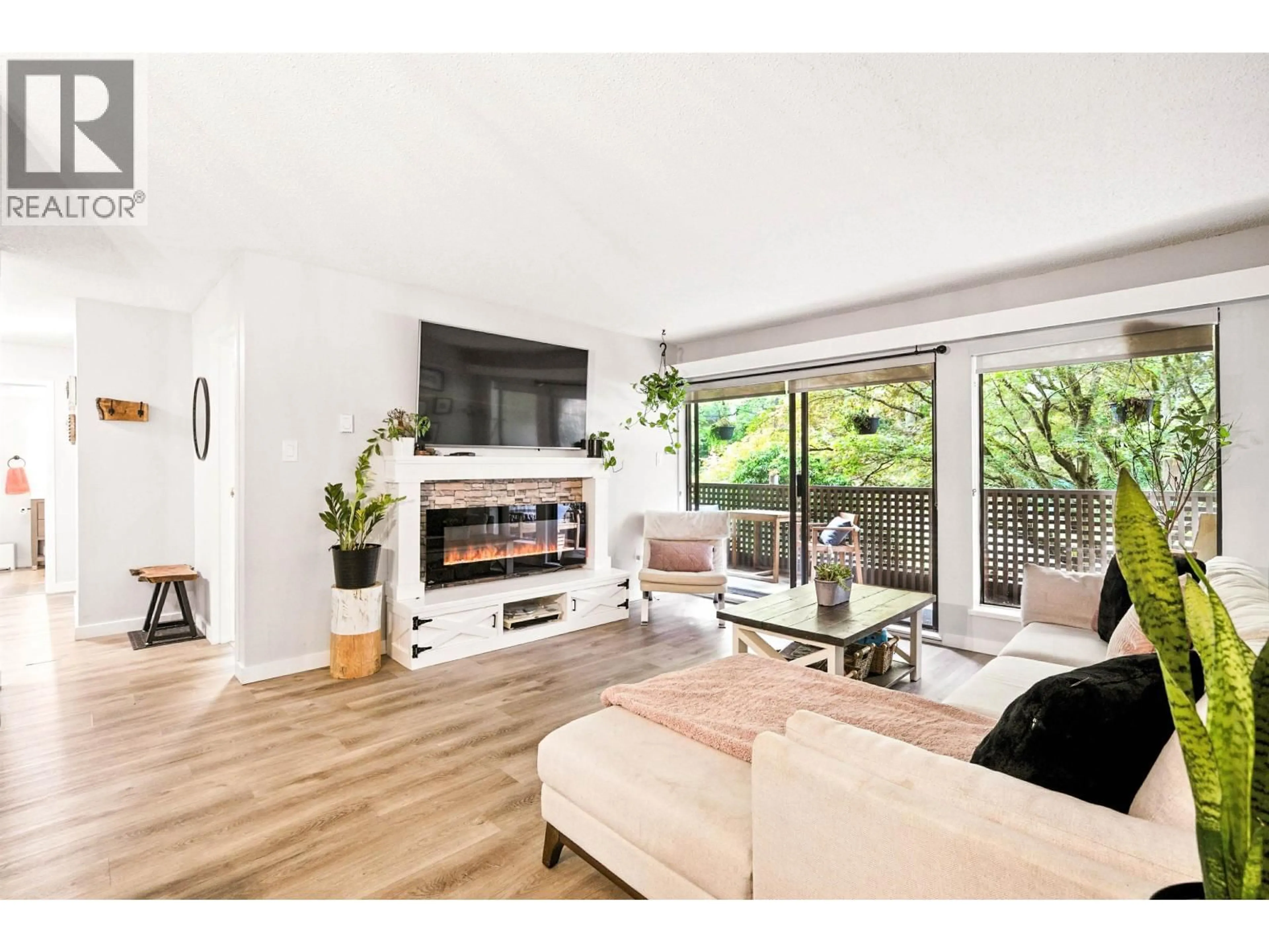 Living room with furniture, wood/laminate floor for 212 - 1955 WOODWAY PLACE, Burnaby British Columbia V5B4S5