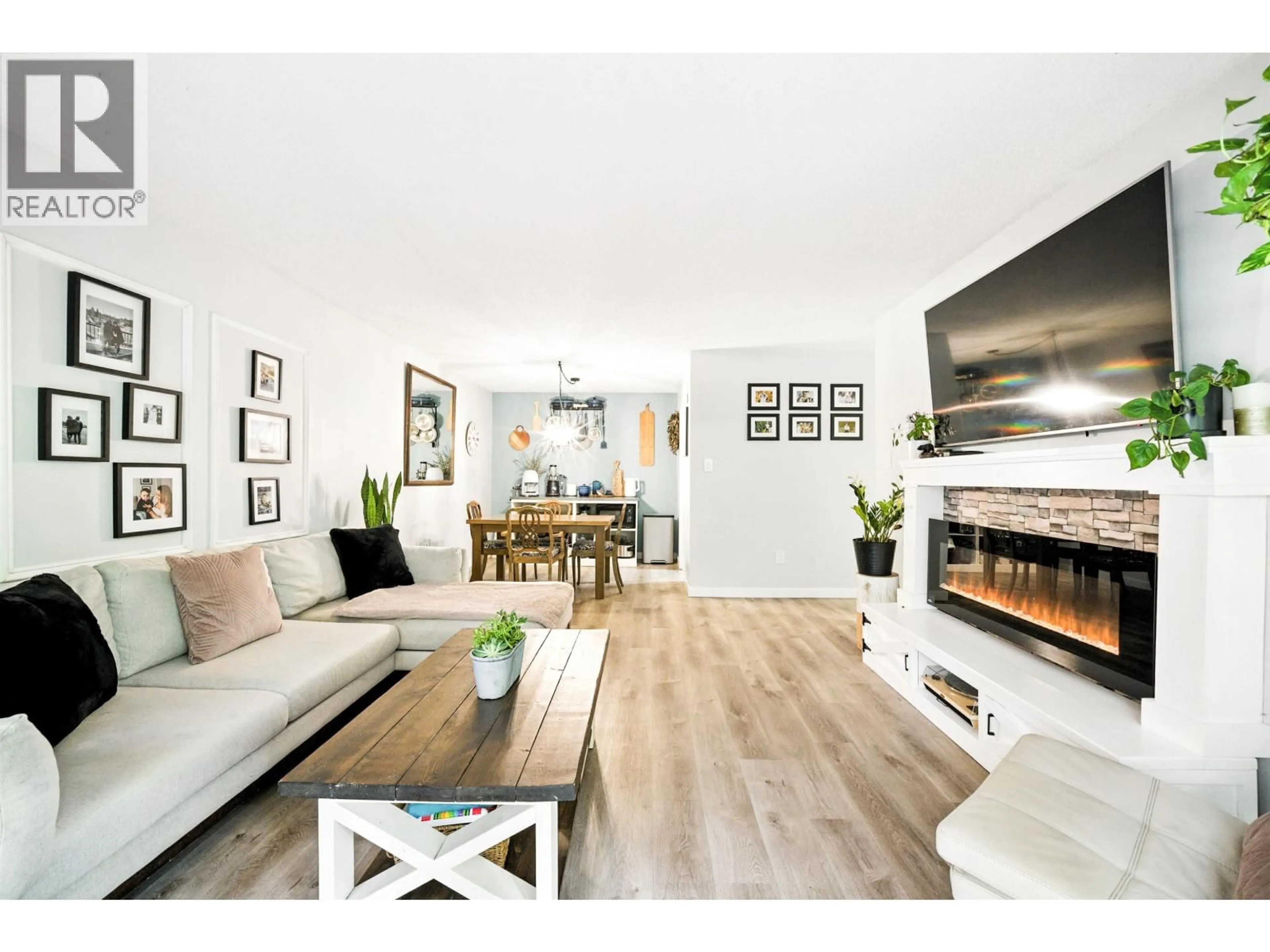 Living room with furniture, wood/laminate floor for 212 - 1955 WOODWAY PLACE, Burnaby British Columbia V5B4S5