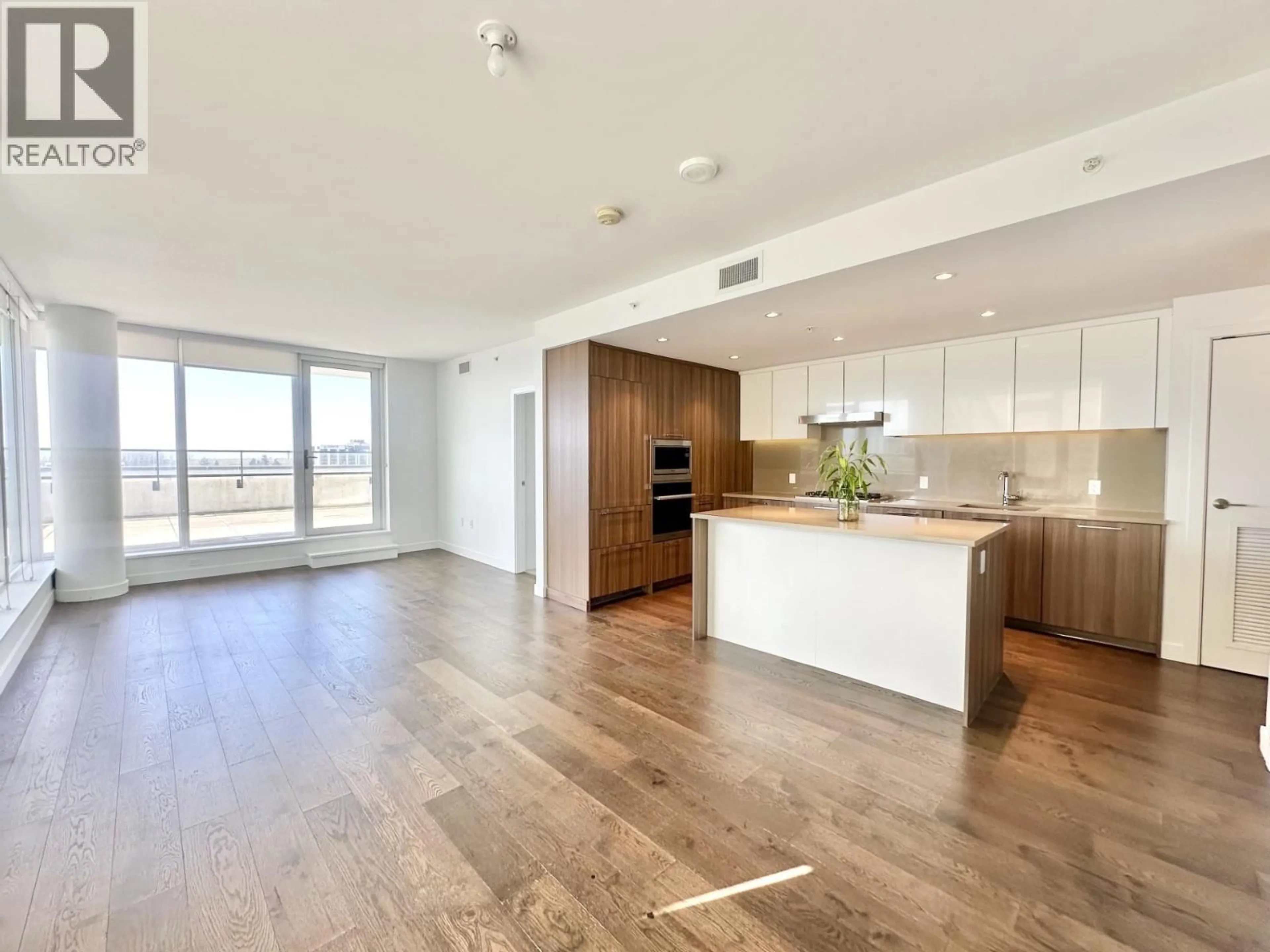 Open concept kitchen, wood/laminate floor for 1005 - 3280 CORVETTE WAY, Richmond British Columbia V6X0T9