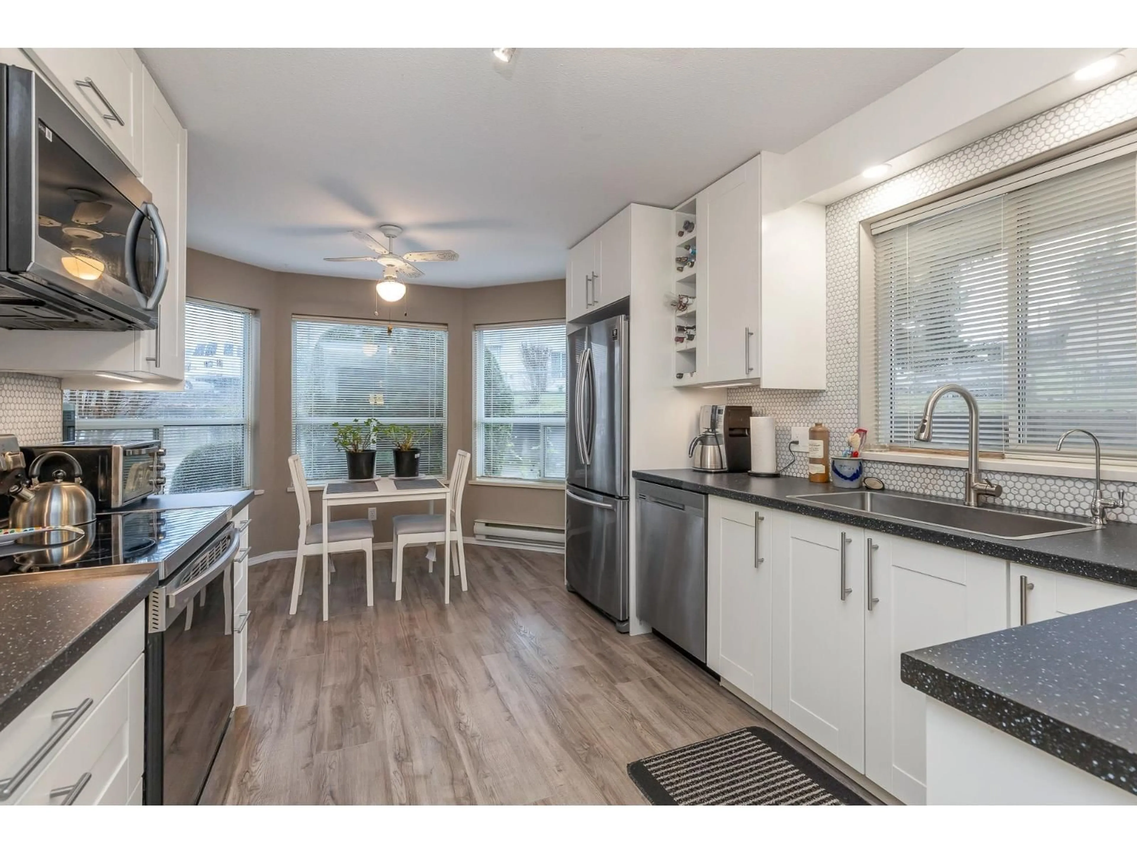 Open concept kitchen, wood/laminate floor for 47 - 3380 GLADWIN ROAD, Abbotsford British Columbia V2S7G1