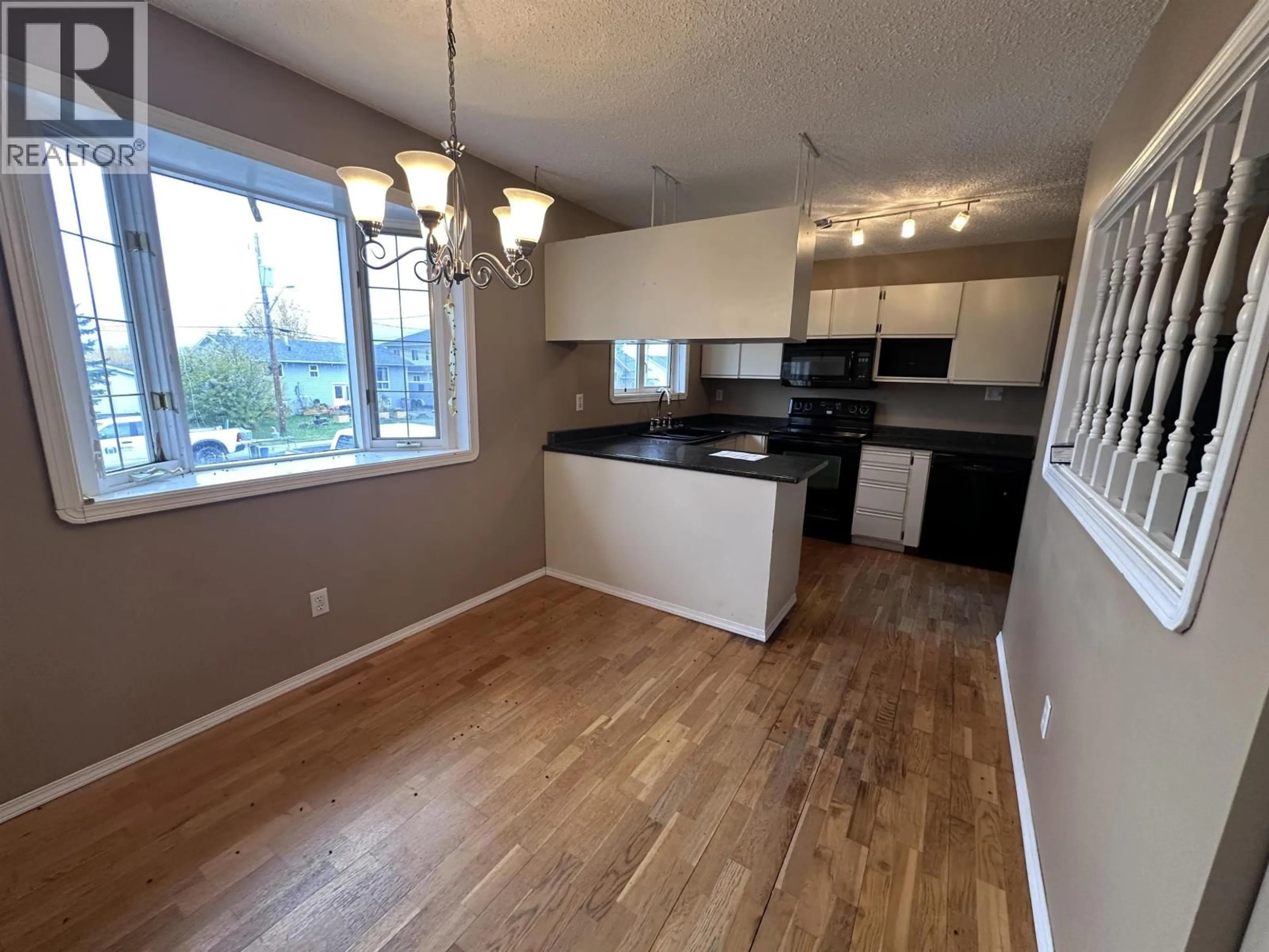 Open concept kitchen, wood/laminate floor for 3916 COTTONWOOD ROAD, Fort Nelson British Columbia V0C1R0