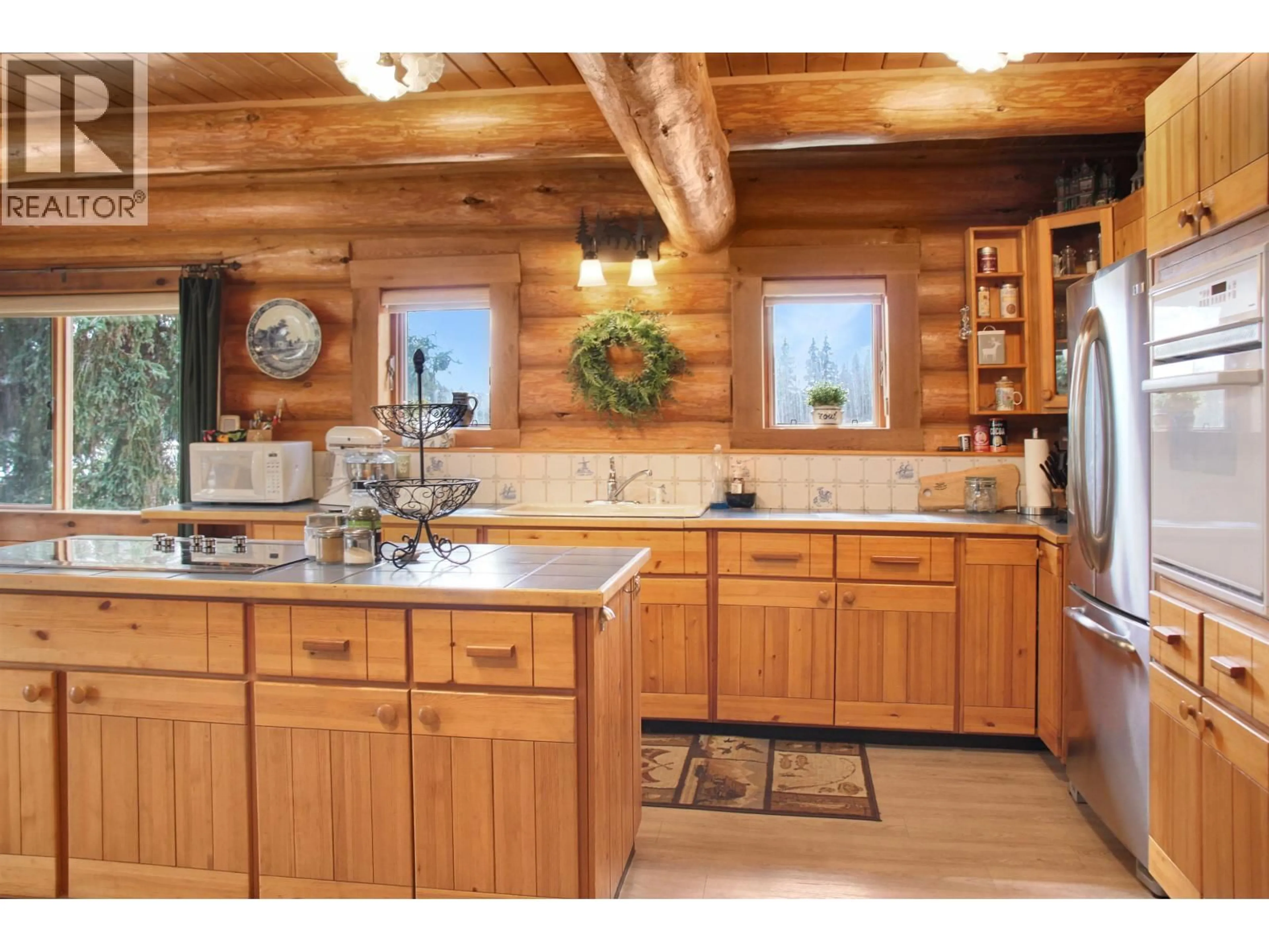 Rustic kitchen, wood/laminate floor for 8025 BONAPARTE ROAD, Bridge Lake British Columbia V0K1E0