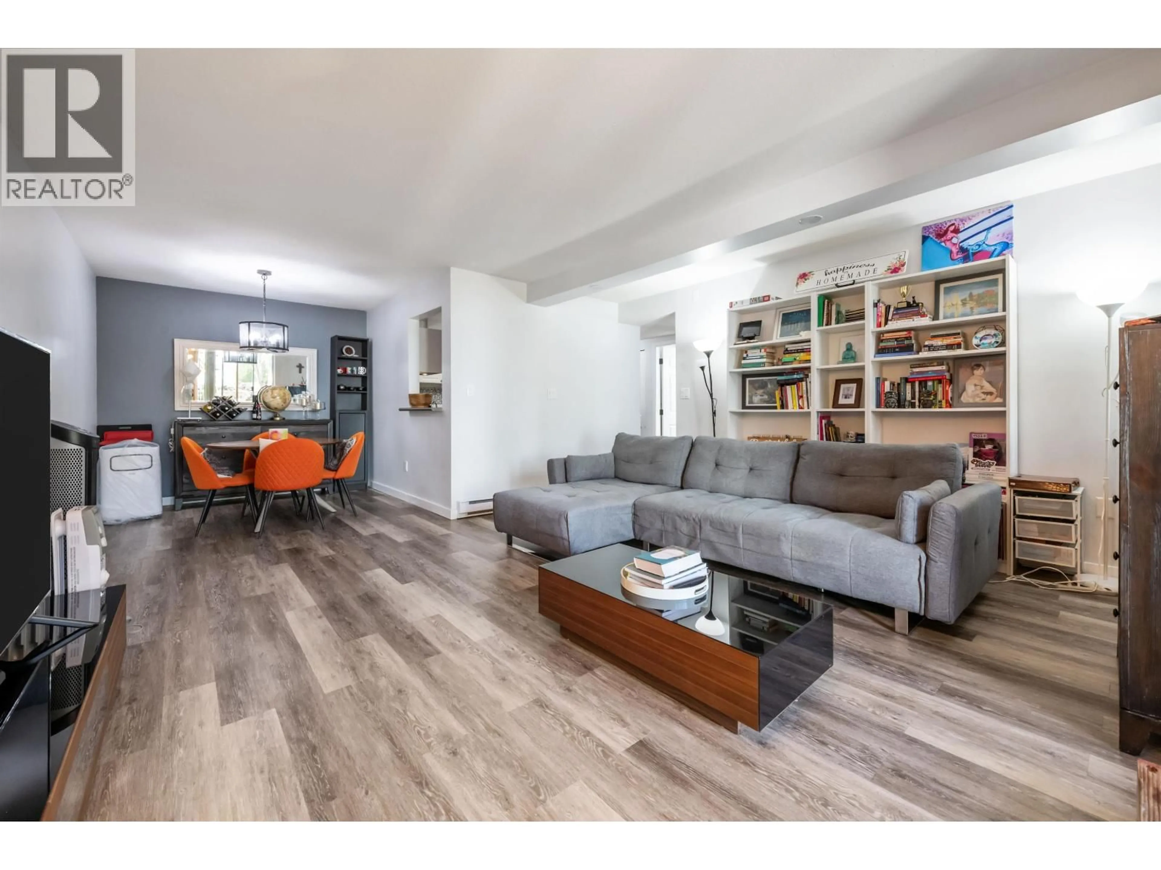 Living room with furniture, wood/laminate floor for 104 - 7471 BLUNDELL ROAD, Richmond British Columbia V6Y1J6