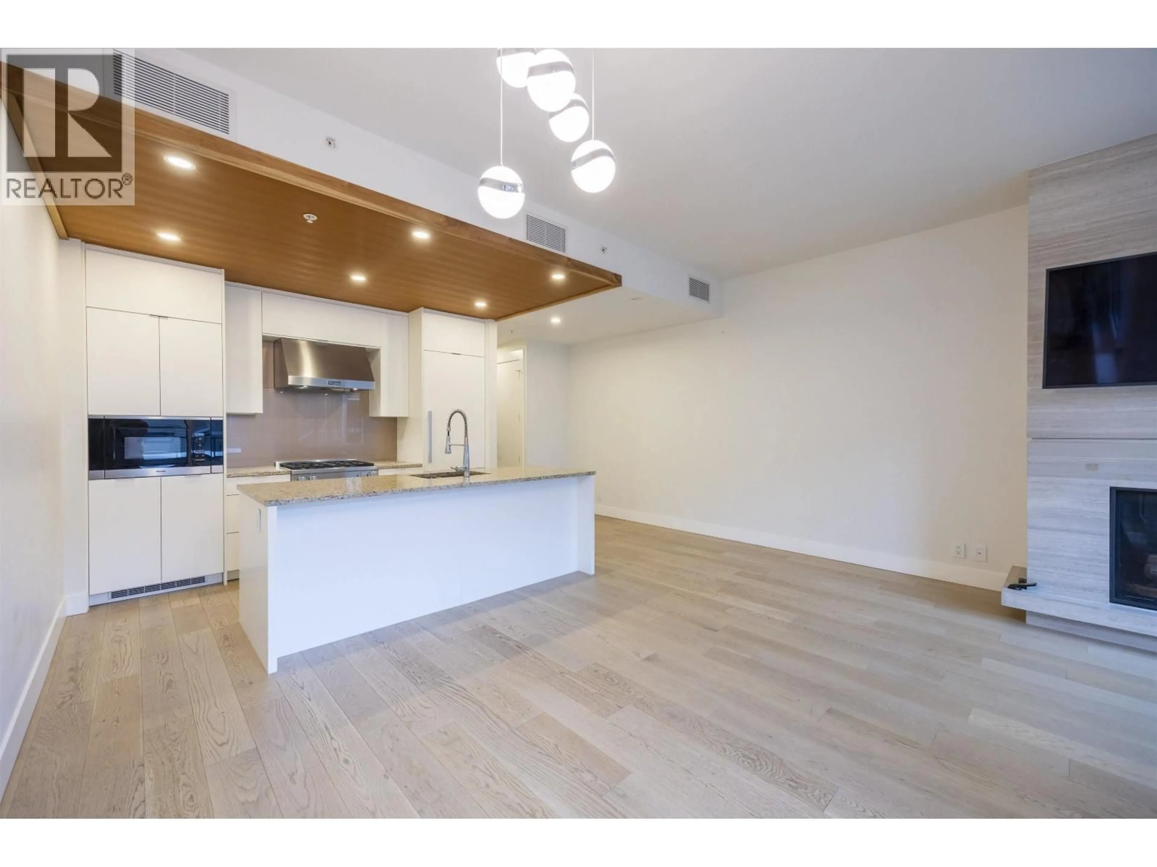 Open concept kitchen, wood/laminate floor for 406 - 6687 NELSON AVENUE, Vancouver British Columbia V7W2B2
