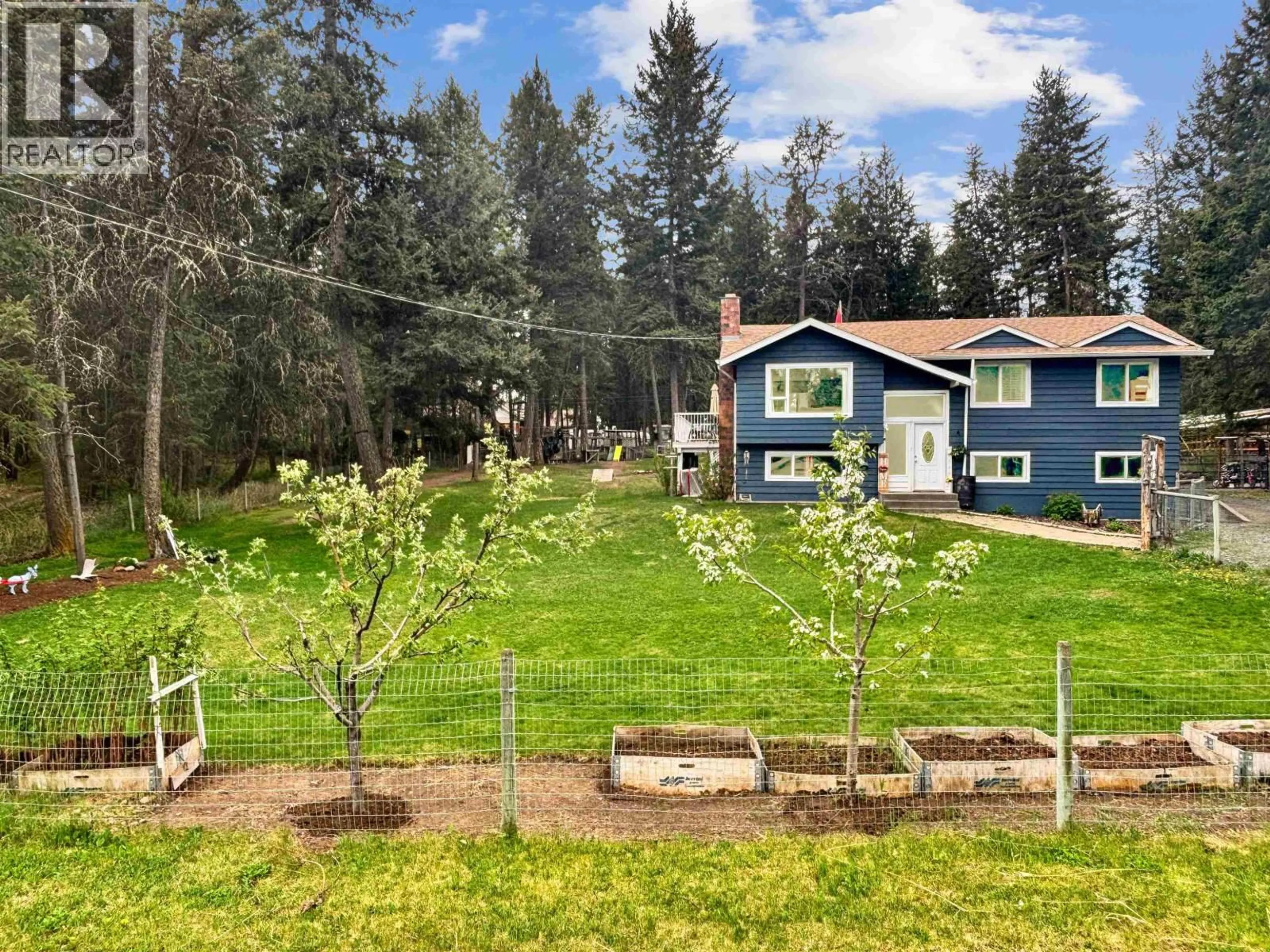 A pic from outside/outdoor area/front of a property/back of a property/a pic from drone, forest/trees view for 5047 EASZEE DRIVE, 108 Mile Ranch British Columbia V0K2Z0