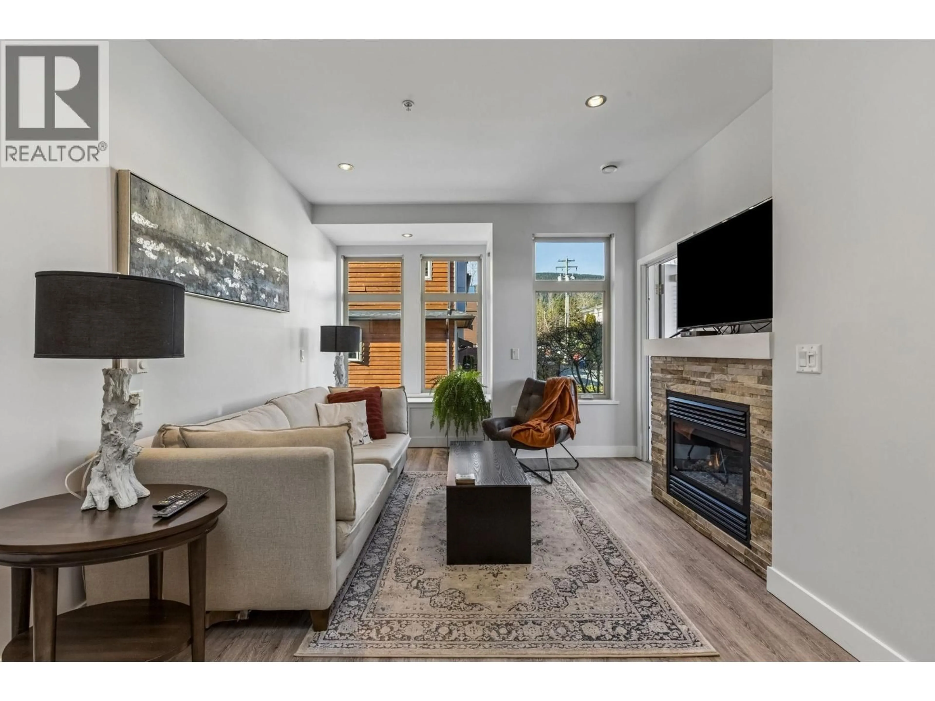 Living room with furniture, wood/laminate floor for 207 - 116 23RD STREET, North Vancouver British Columbia V7M2A9