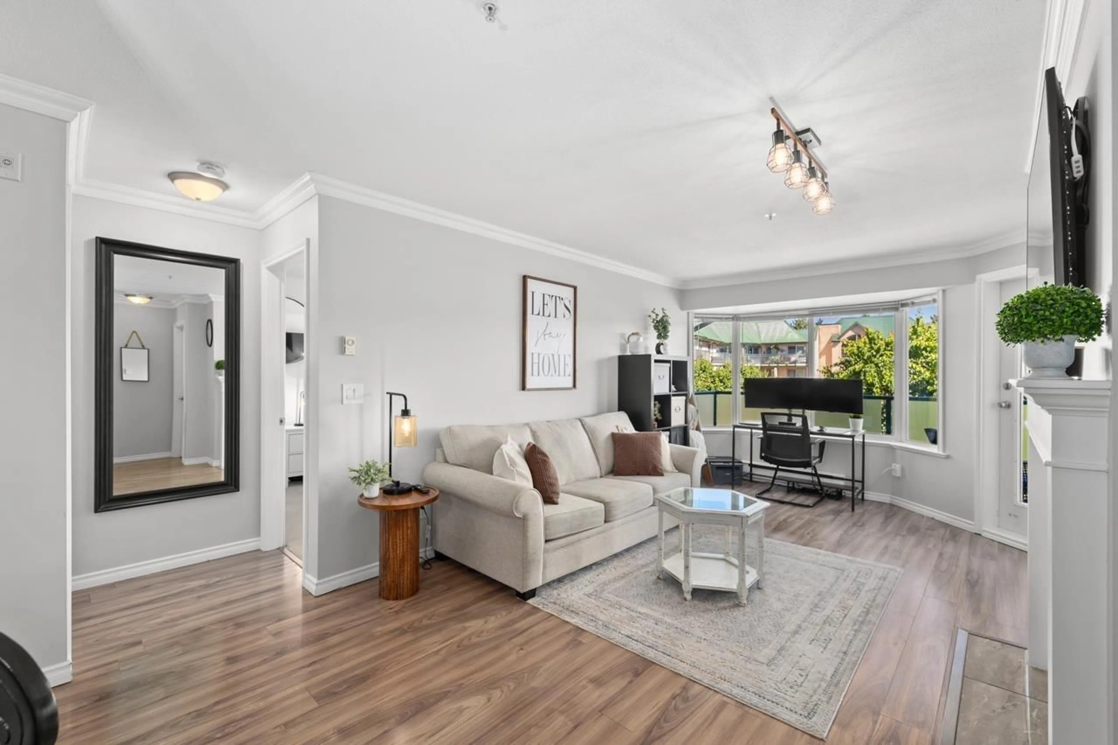 Living room with furniture, wood/laminate floor for 310 - 2958 TRETHEWEY STREET, Abbotsford British Columbia V2T6P6