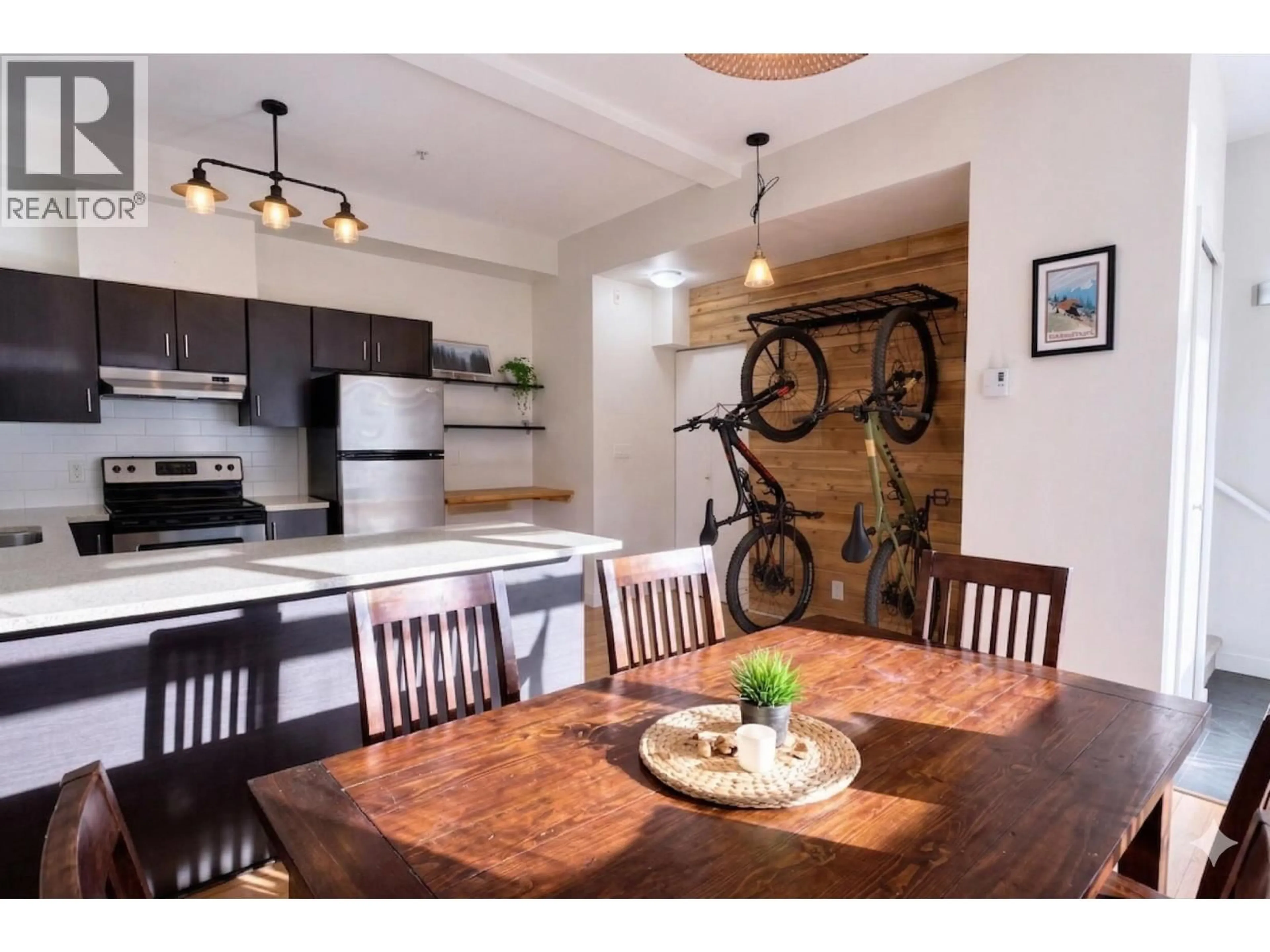 Open concept kitchen, wood/laminate floor for 103 - 41105 TANTALUS ROAD, Squamish British Columbia V8B0N3