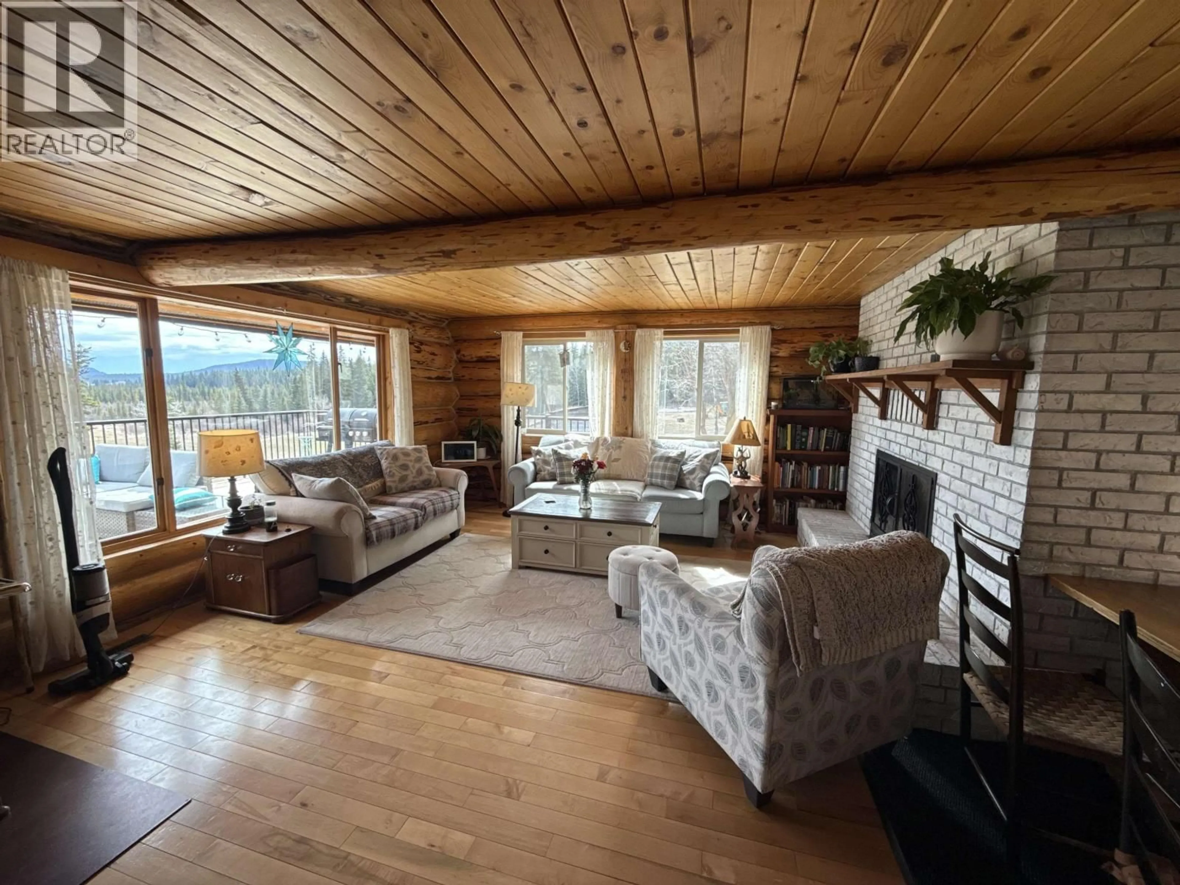 Living room with furniture, wood/laminate floor for 3041 MELDRUM CREEK ROAD, Williams Lake British Columbia V2G5M8