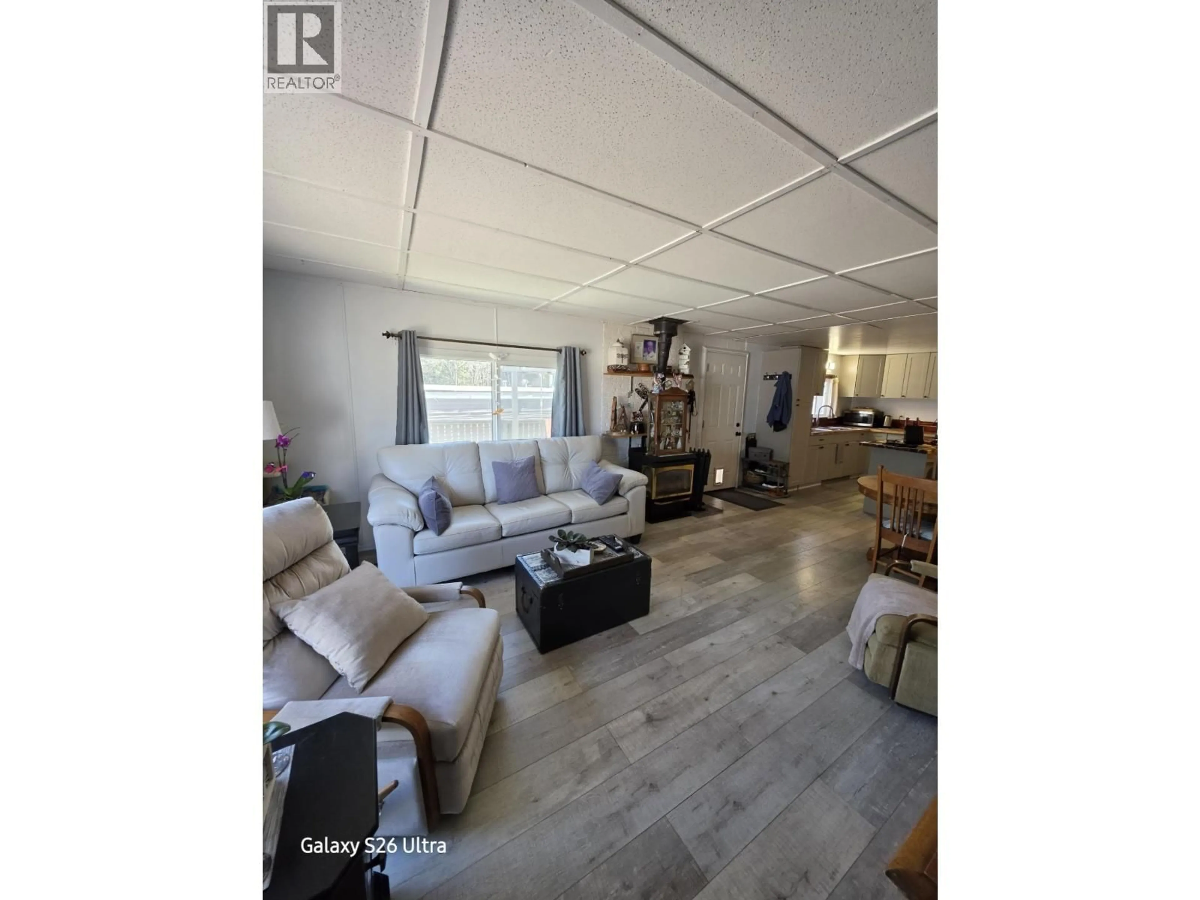 Living room with furniture, wood/laminate floor for 212 - 1427 DOG CREEK ROAD, Williams Lake British Columbia V2G3H3