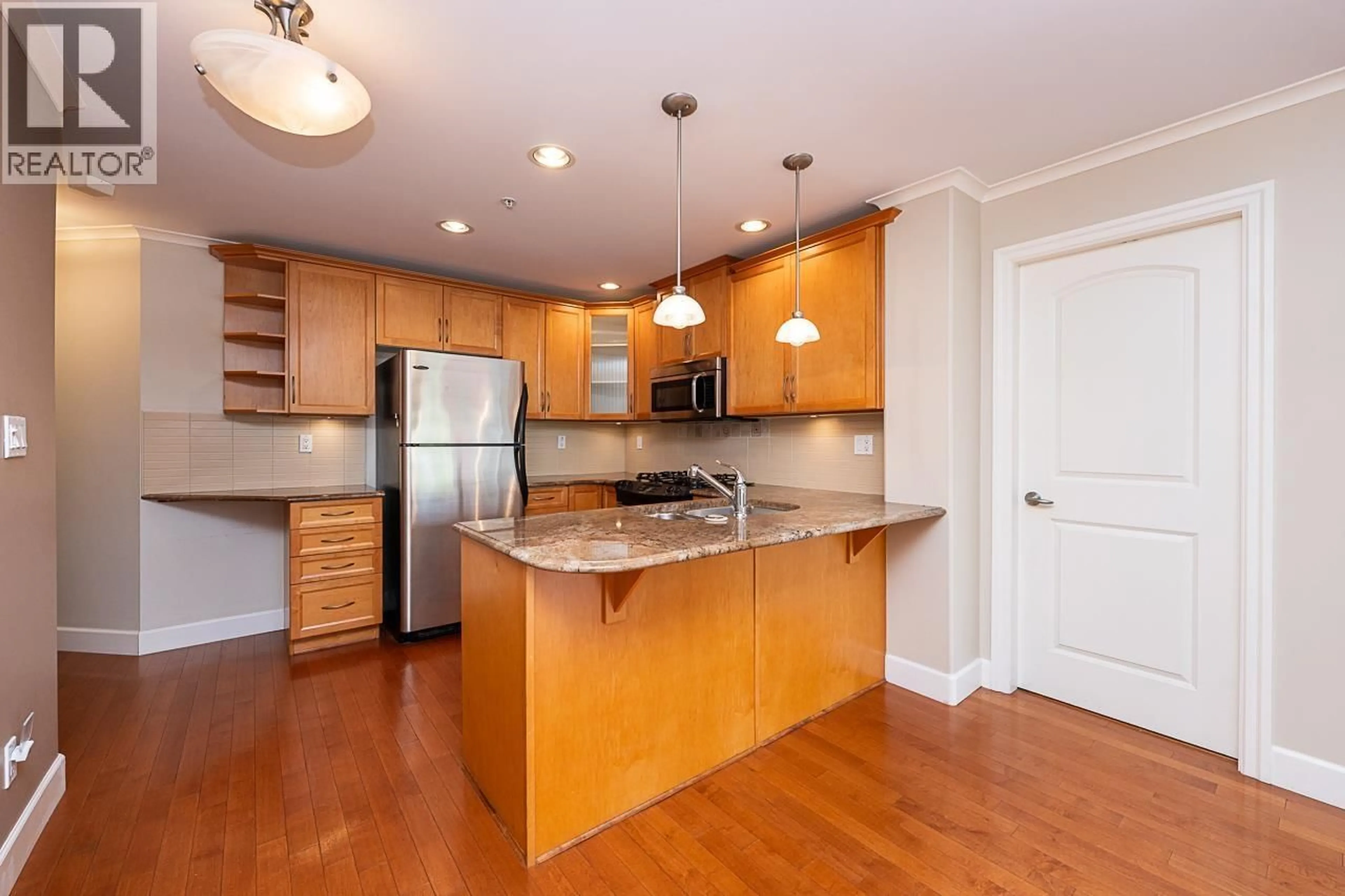 Open concept kitchen, wood/laminate floor for 203 - 2103 45TH AVENUE, Vancouver British Columbia V6M2J2