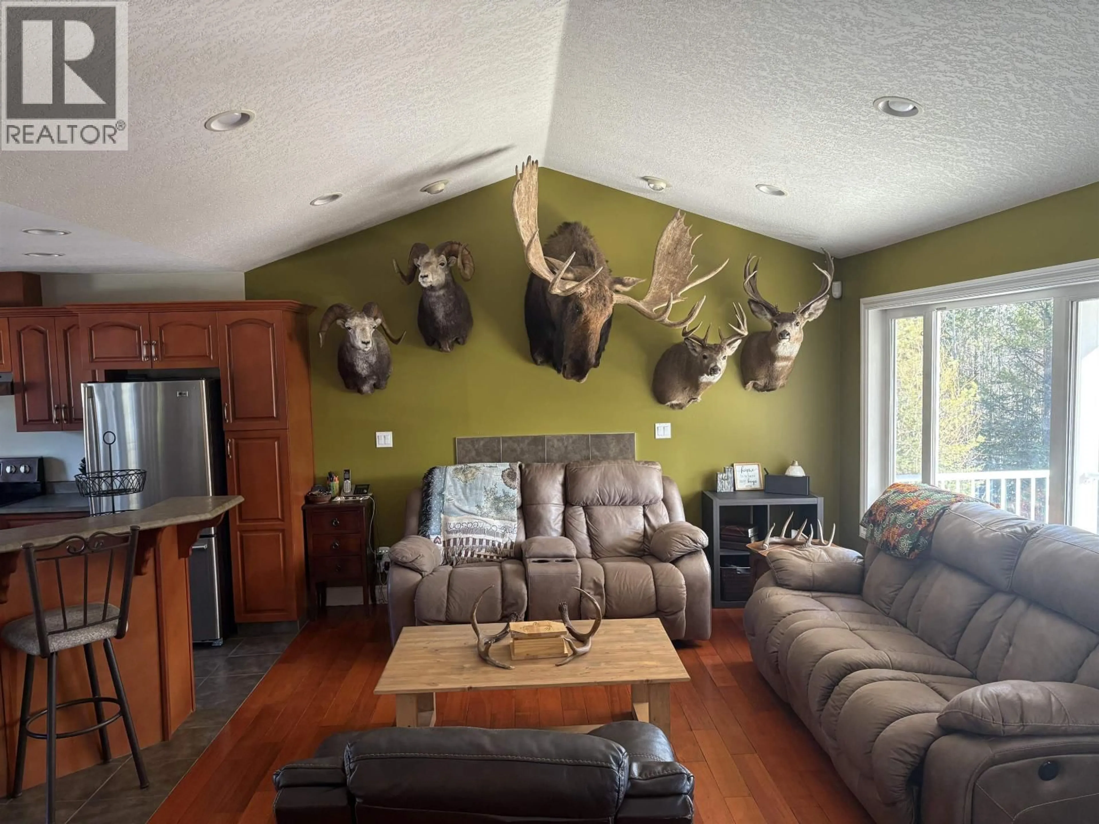 Living room with furniture, wood/laminate floor for 9133 SYKES ROAD, Prince George British Columbia V2N6N4