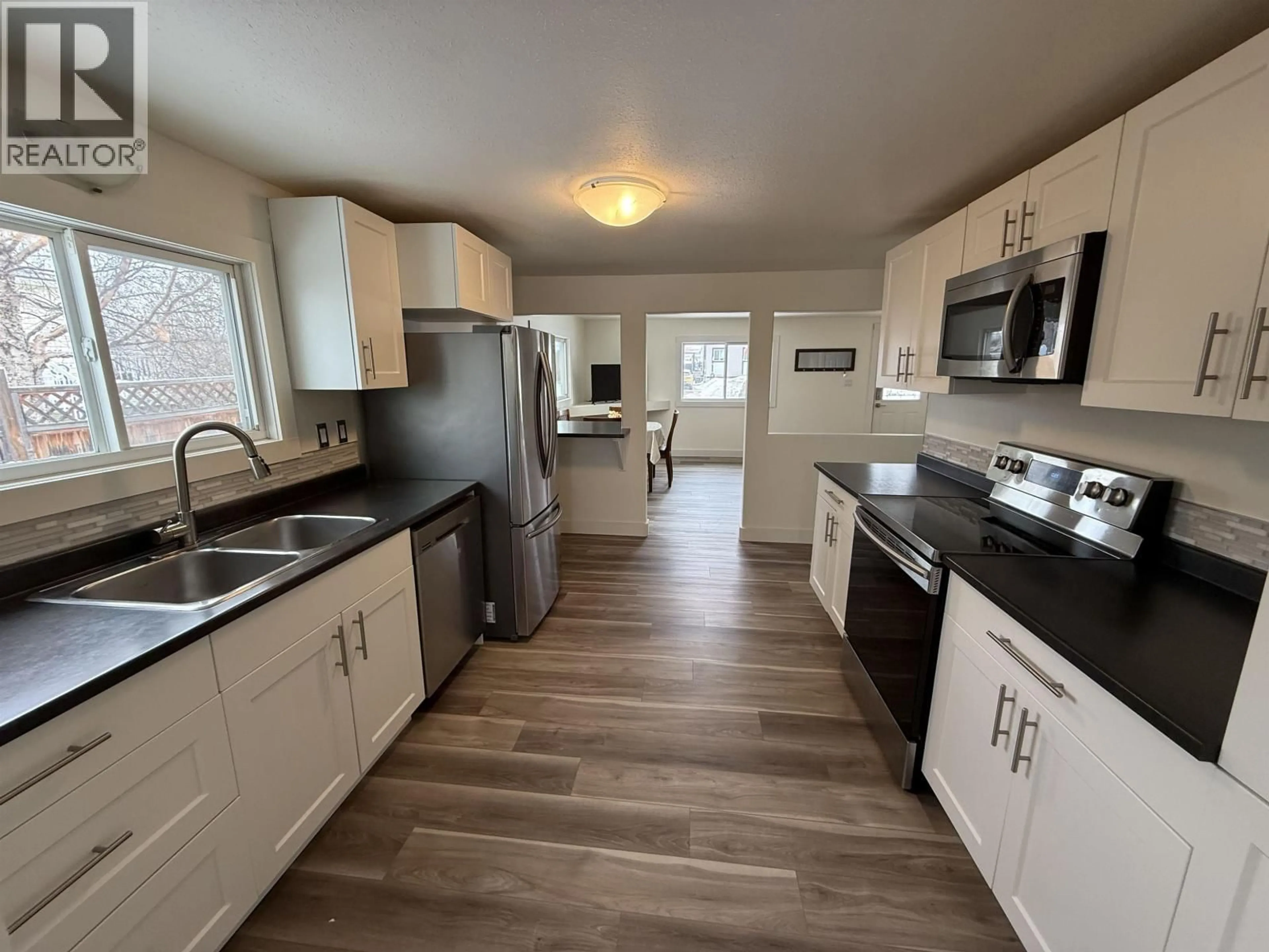 Open concept kitchen, unknown for 8620 77 STREET, Fort St. John British Columbia V1J3A2