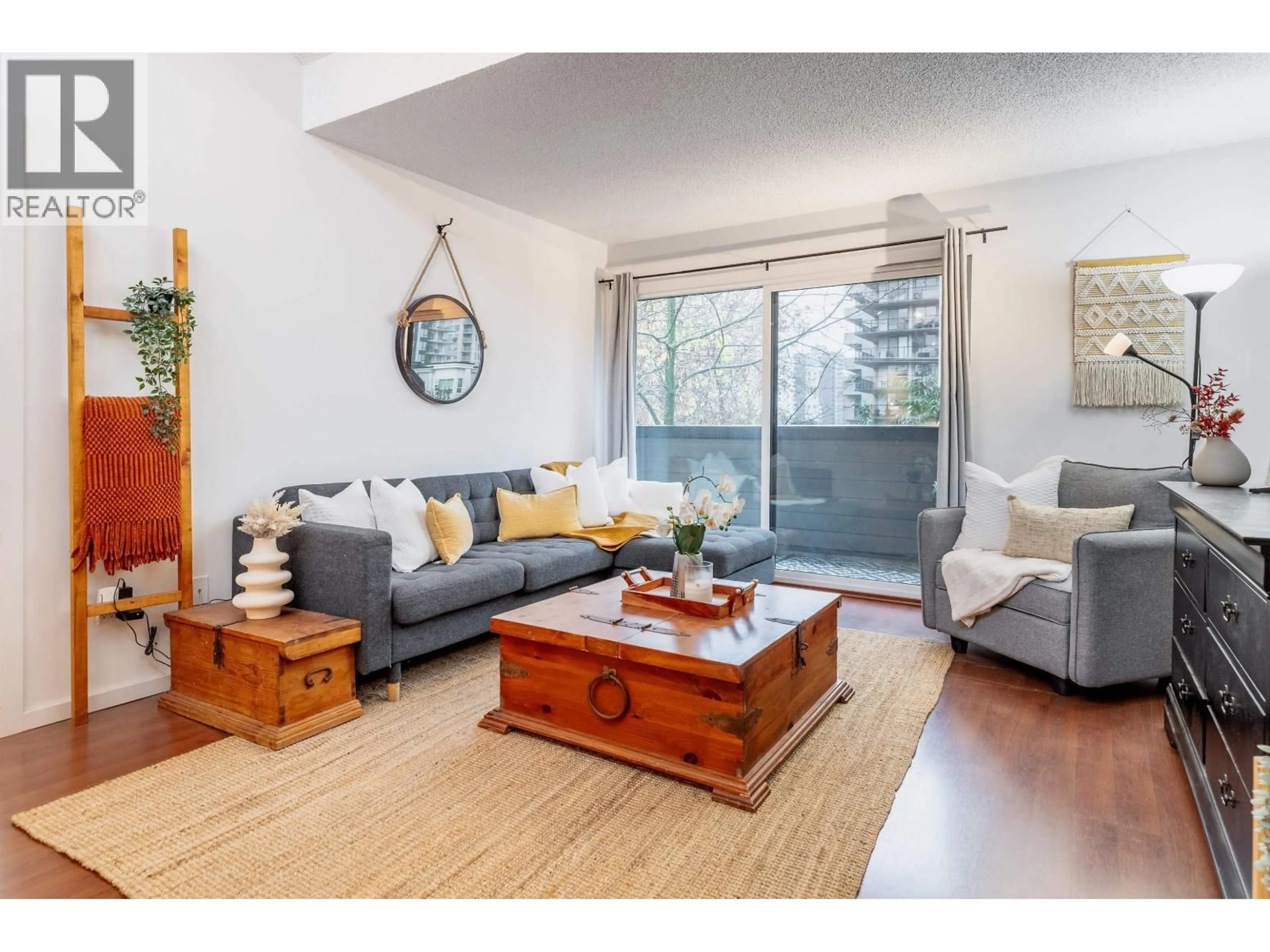 Living room with furniture, wood/laminate floor for 319 - 206 15TH STREET, North Vancouver British Columbia V7L2R3
