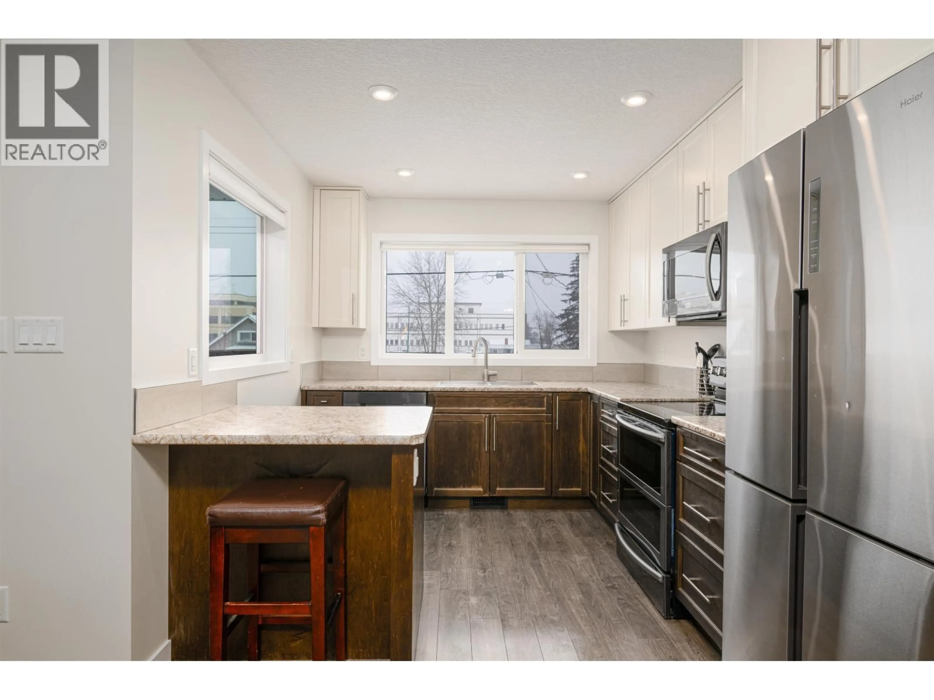 Open concept kitchen, wood/laminate floor for 1740 5TH AVENUE, Prince George British Columbia V2L3M3