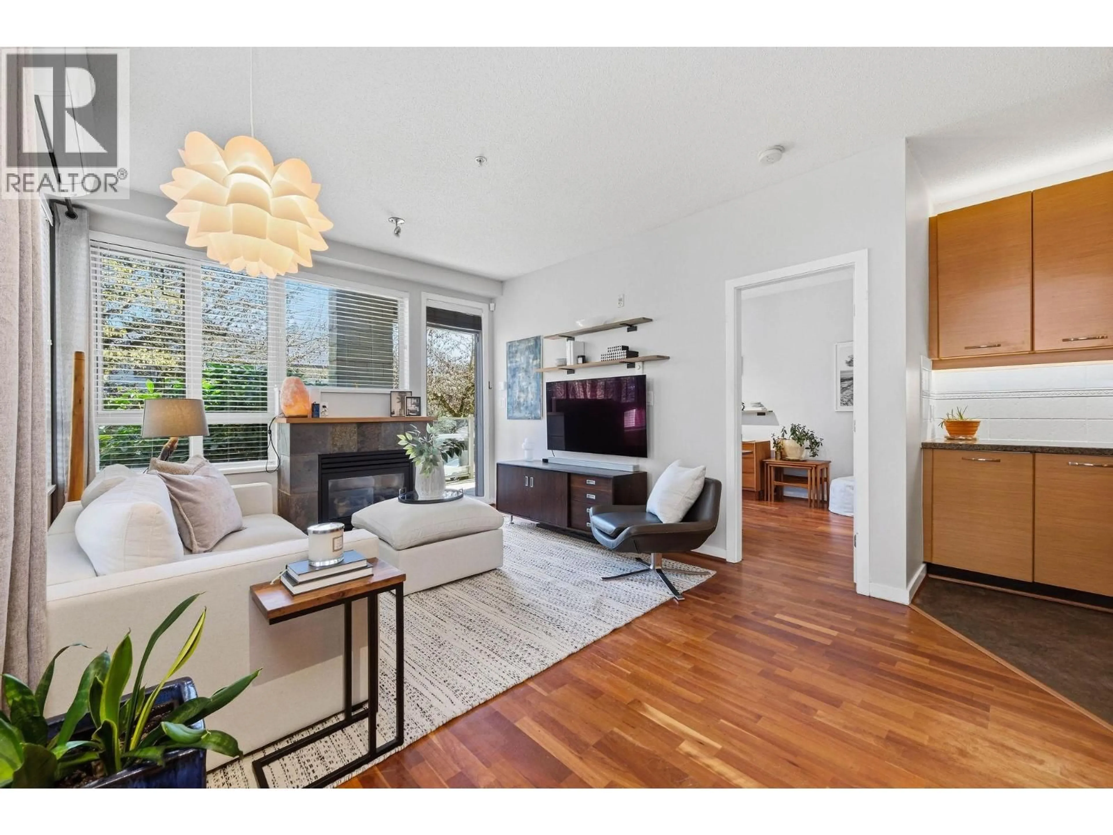 Living room with furniture, wood/laminate floor for 223 - 530 RAVEN WOODS DRIVE, North Vancouver British Columbia V7G2T5