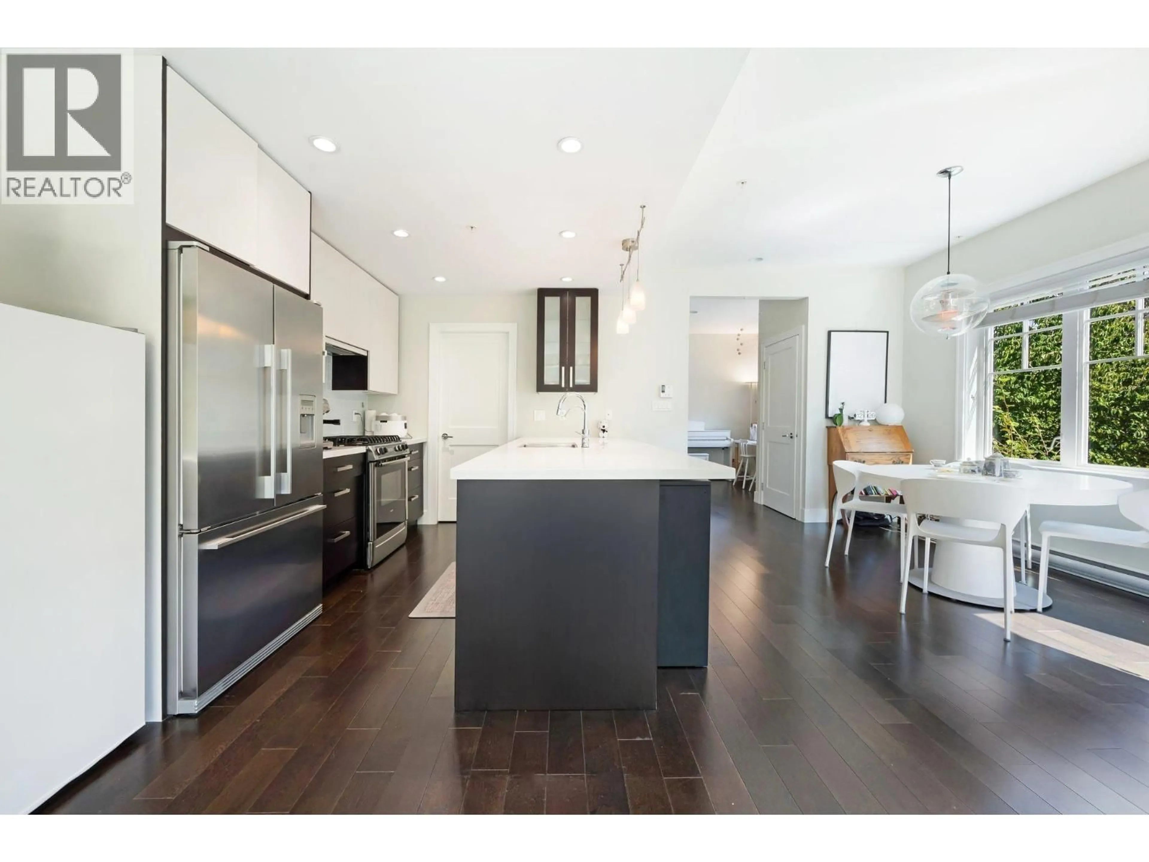 Open concept kitchen, wood/laminate floor for 1483 TILNEY MEWS, Vancouver British Columbia V6P0B1