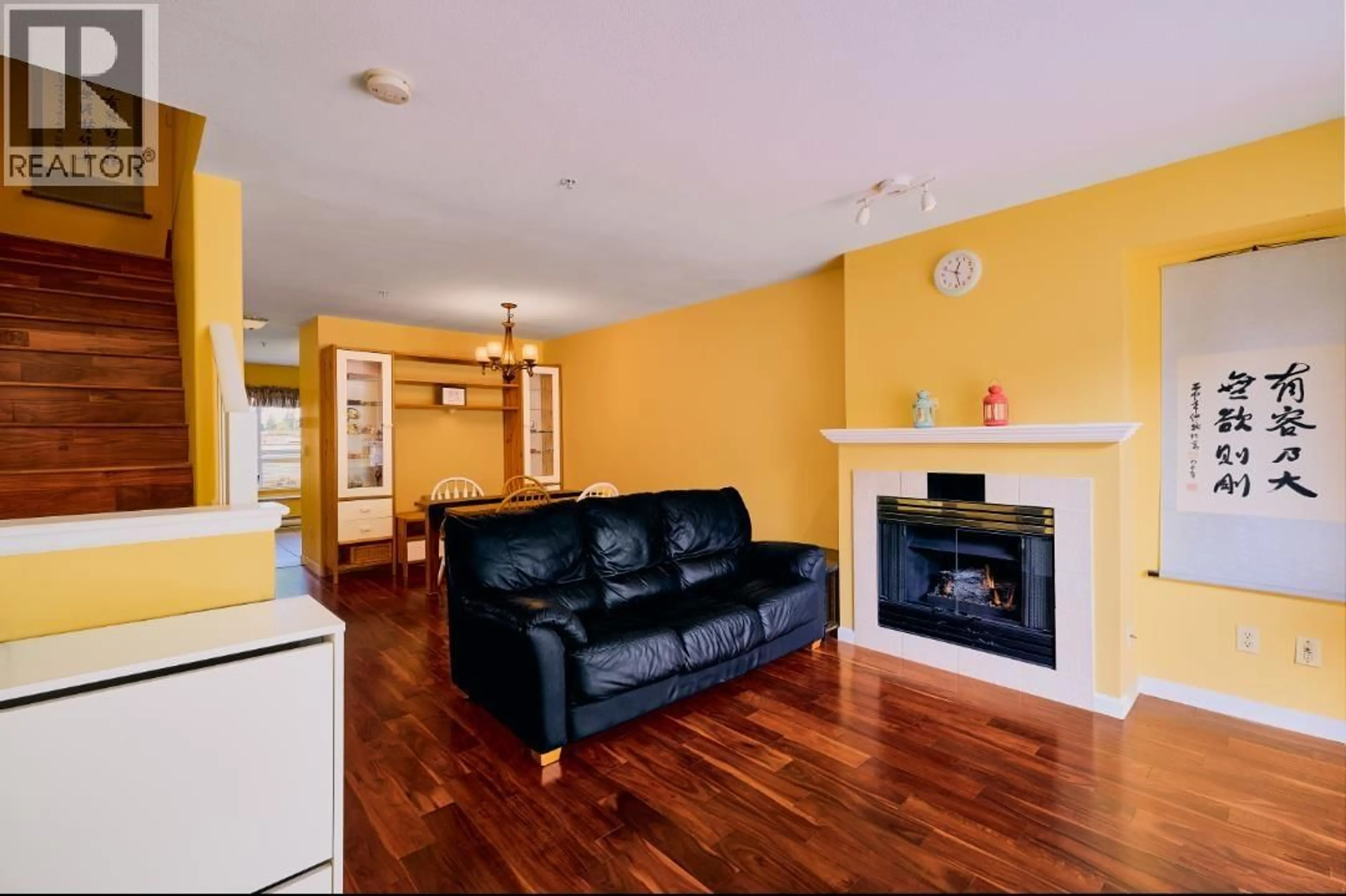 Living room with furniture, wood/laminate floor for 117 - 6588 SOUTHOAKS CRESCENT, Burnaby British Columbia V5E4K1