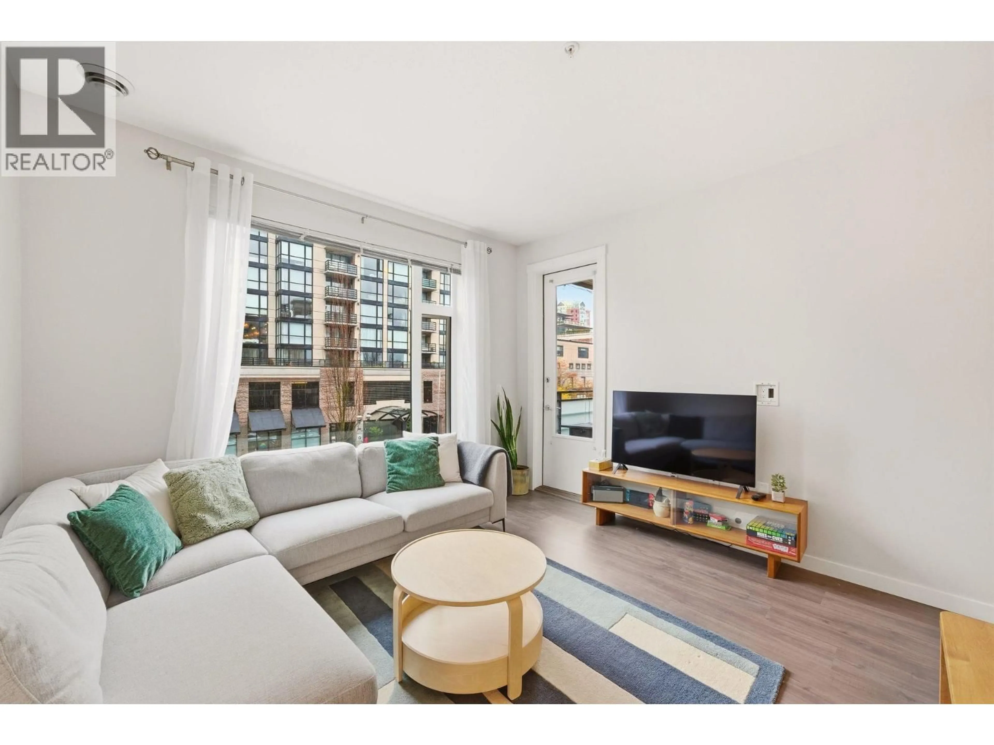 Living room with furniture, wood/laminate floor for 304 - 123 1ST STREET, North Vancouver British Columbia V7M0E5