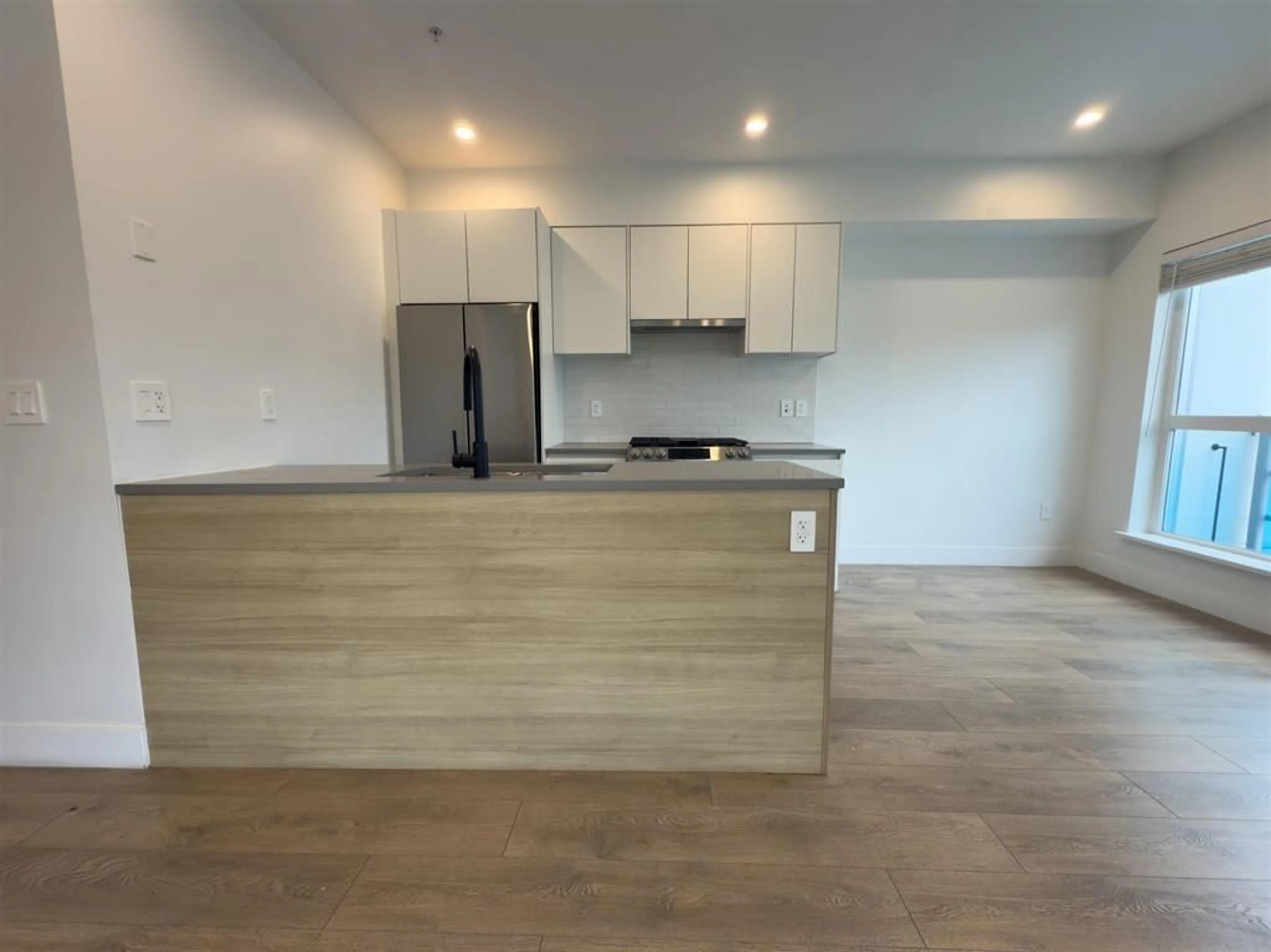 Open concept kitchen, wood/laminate floor for 213 - 8496 120 STREET, Surrey British Columbia V3W3N5