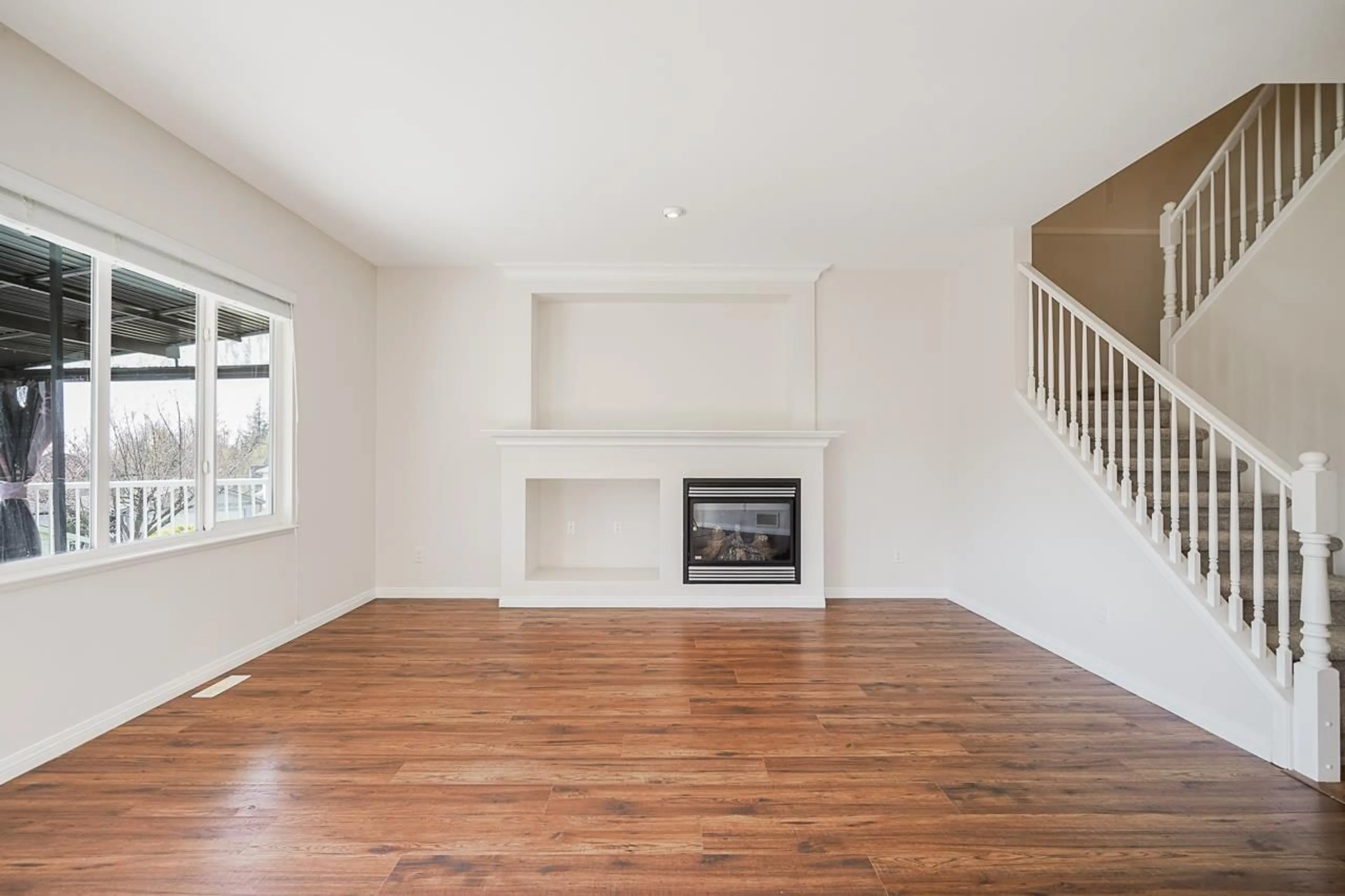 Living room with furniture, wood/laminate floor for 36016 SHADBOLT AVENUE, Abbotsford British Columbia V3G3E6