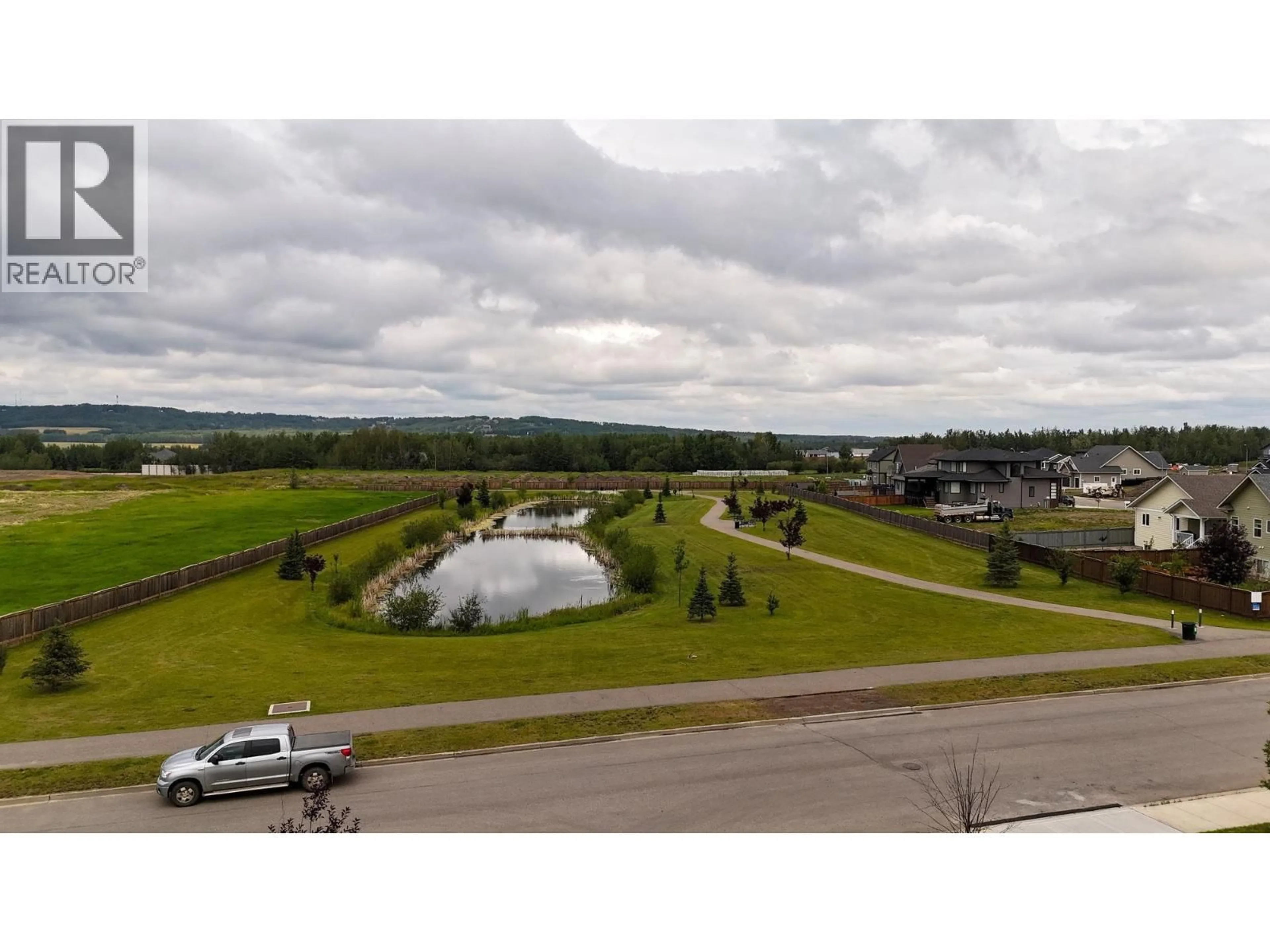 A pic from outside/outdoor area/front of a property/back of a property/a pic from drone, water/lake/river/ocean view for 213 - 11205 105 AVENUE, Fort St. John British Columbia V1J0L3