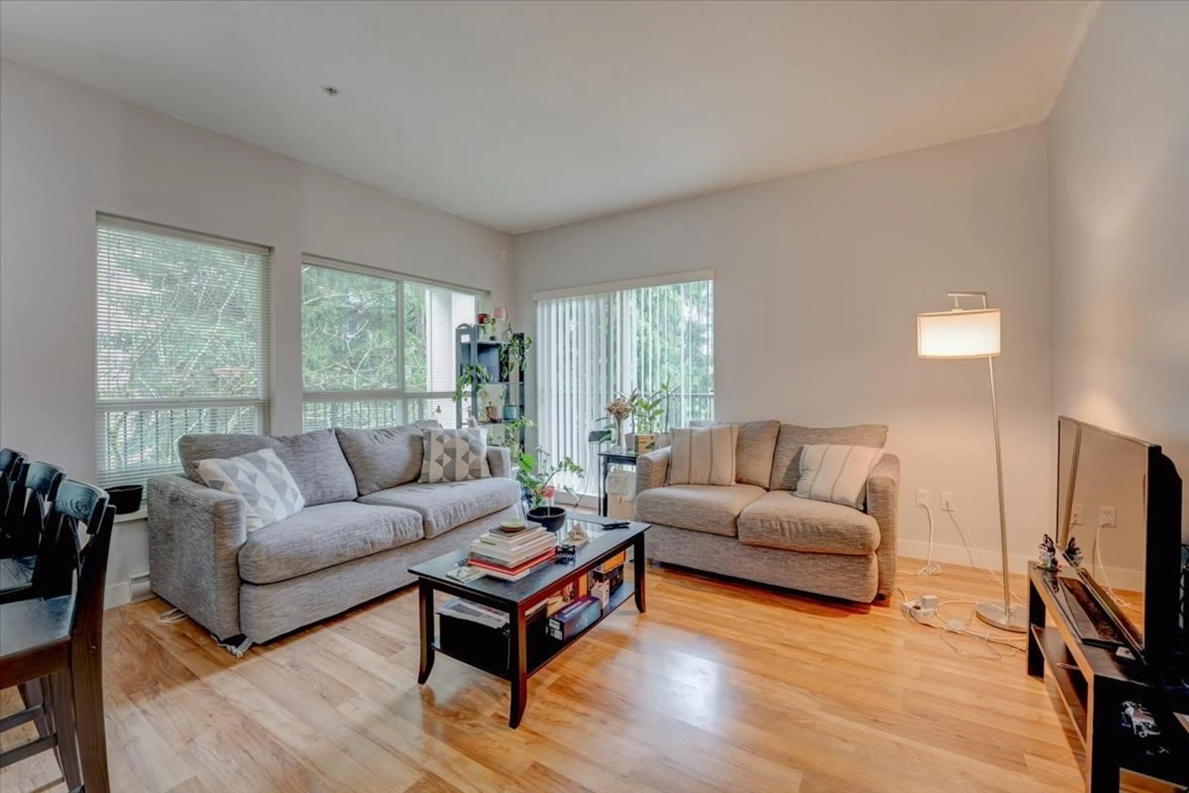 Living room with furniture, wood/laminate floor for 215 - 9655 KING GEORGE BOULEVARD, Surrey British Columbia V3T0C7