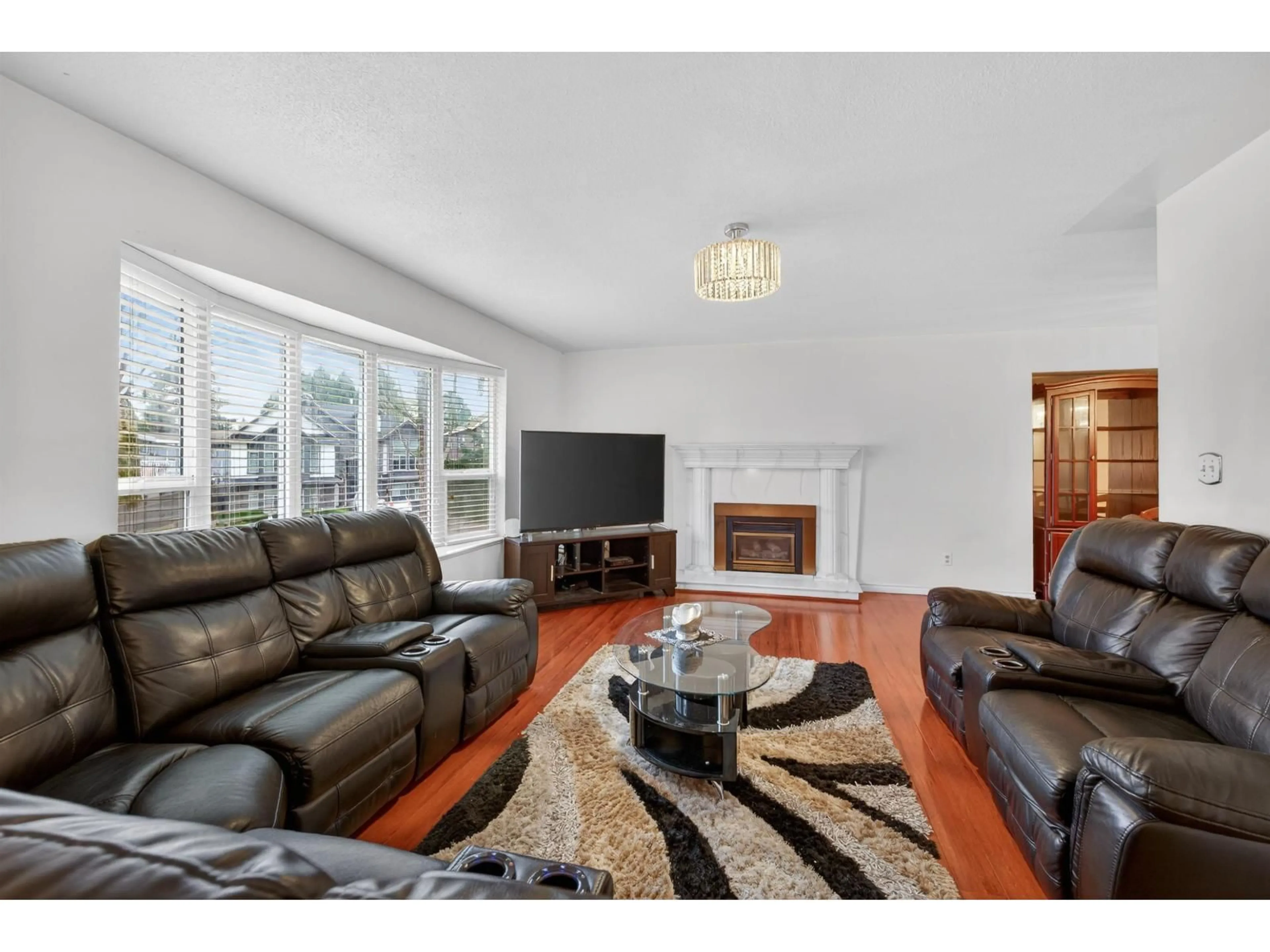 Living room with furniture, wood/laminate floor for 8927 146A STREET, Surrey British Columbia V3R6Z9