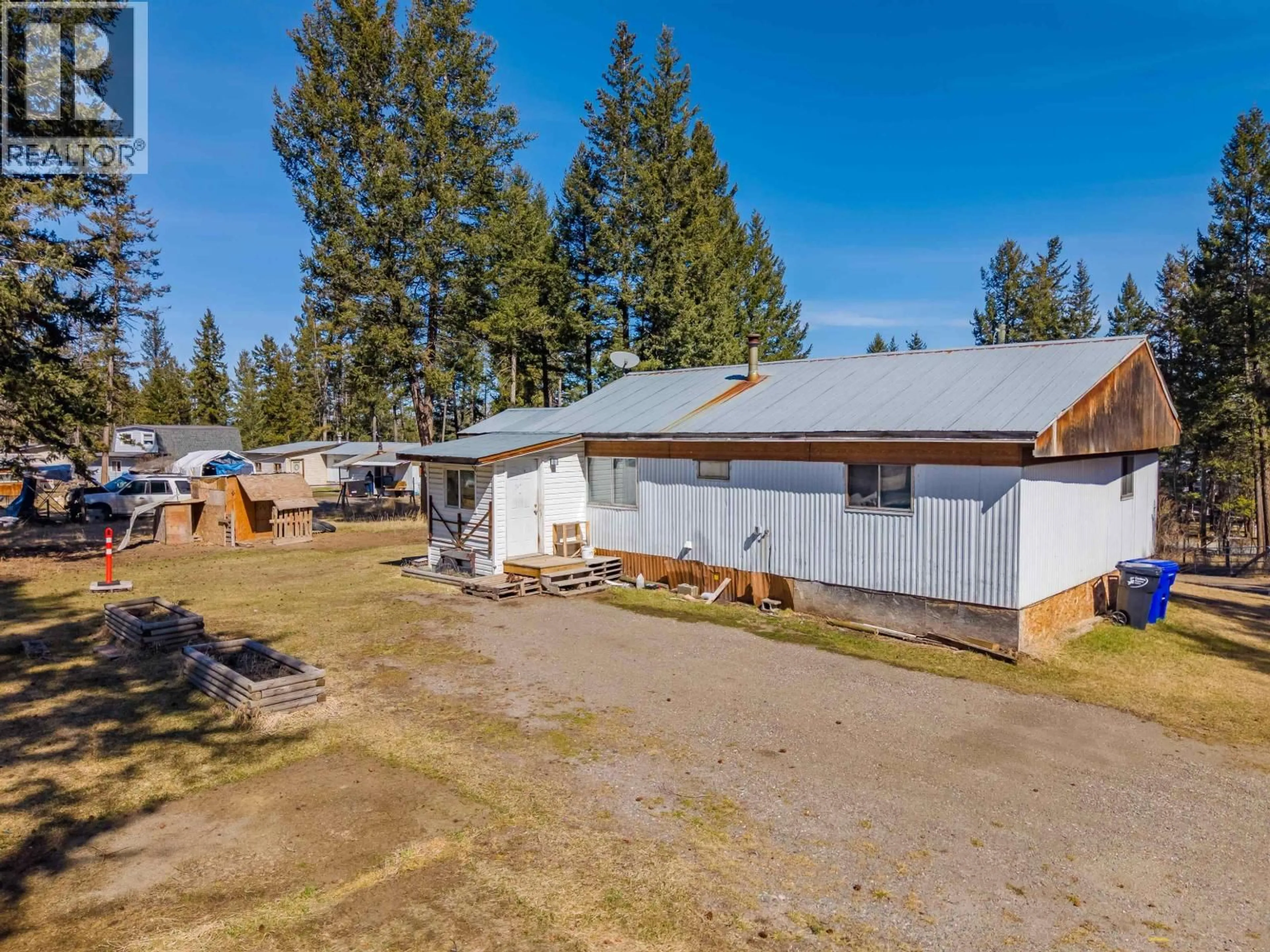 A pic from outside/outdoor area/front of a property/back of a property/a pic from drone, unknown for 5469 SAUNDERS CRESCENT, 103 Mile House British Columbia V0K2E1