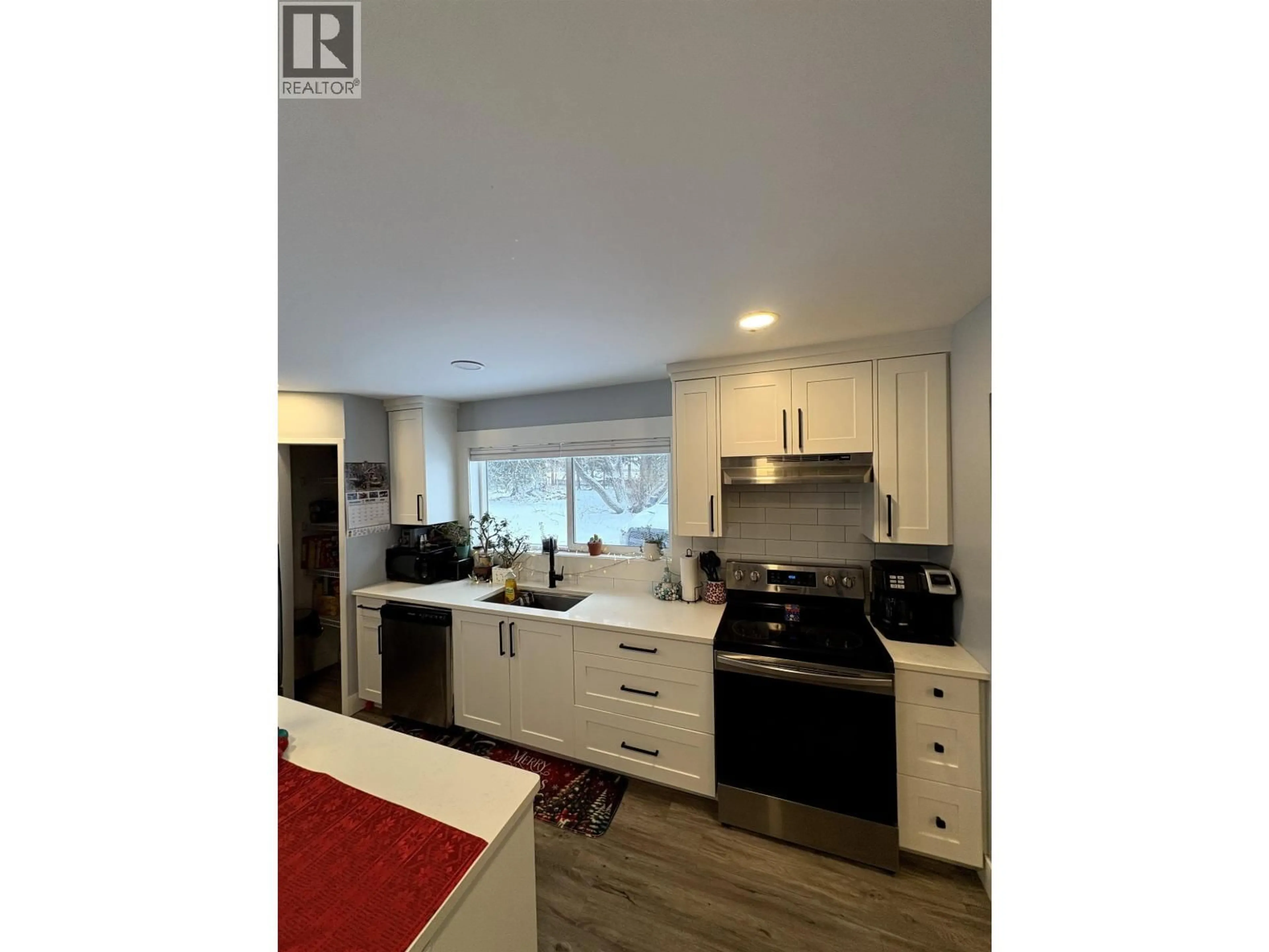 Open concept kitchen, wood/laminate floor for 7802 GISCOME ROAD, Prince George British Columbia V2N6V1