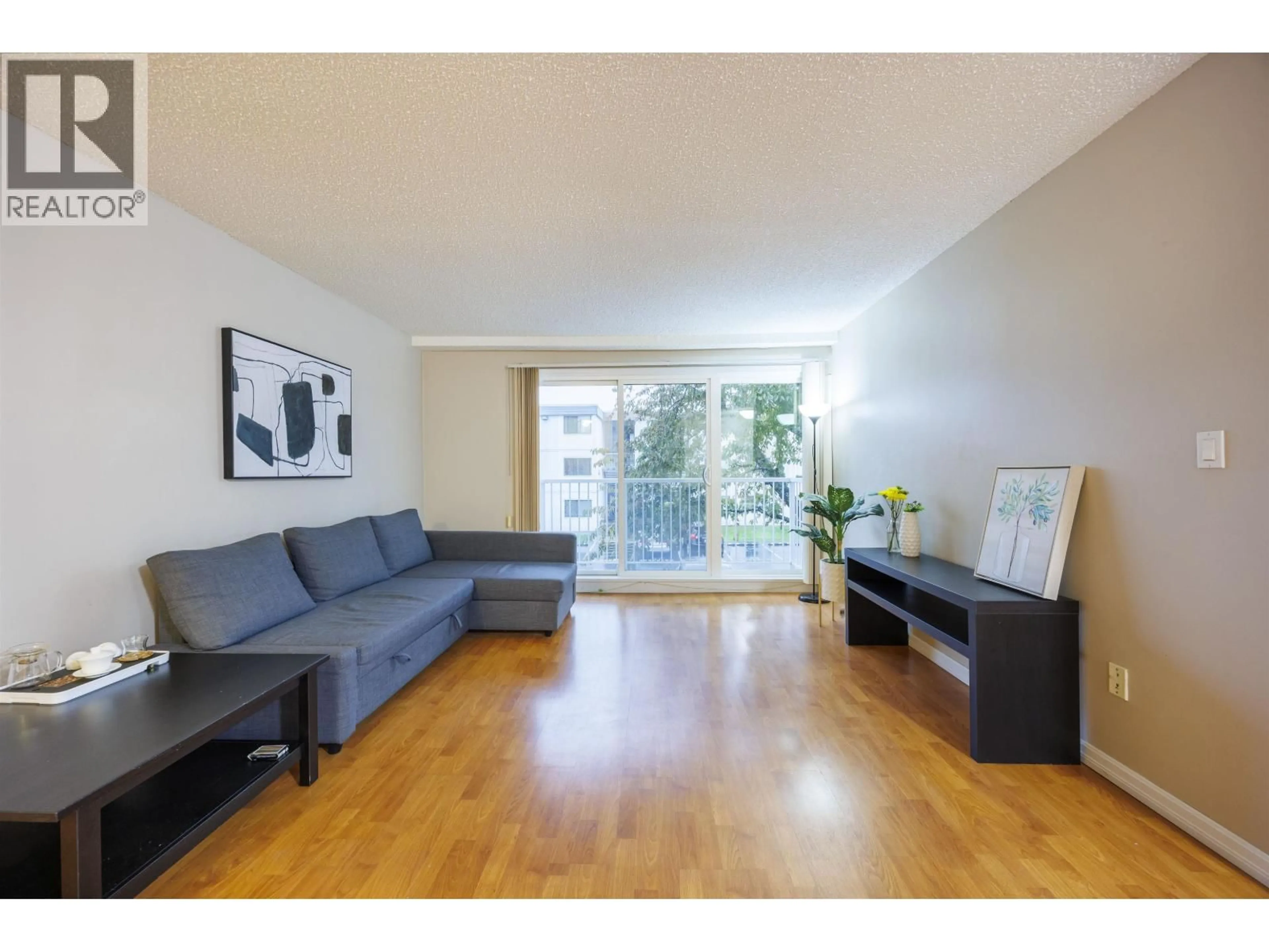 Living room with furniture, wood/laminate floor for 201 - 7200 LINDSAY ROAD, Richmond British Columbia V7C3M6