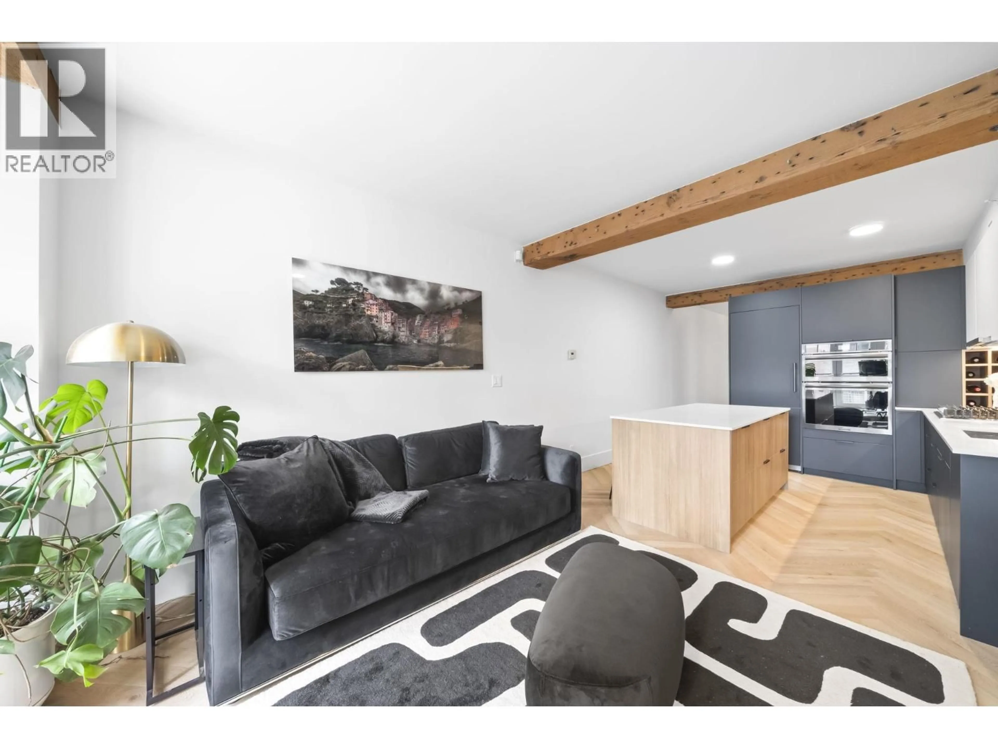 Living room with furniture, wood/laminate floor for 202 - 1275 HAMILTON STREET, Vancouver British Columbia V6B1E2