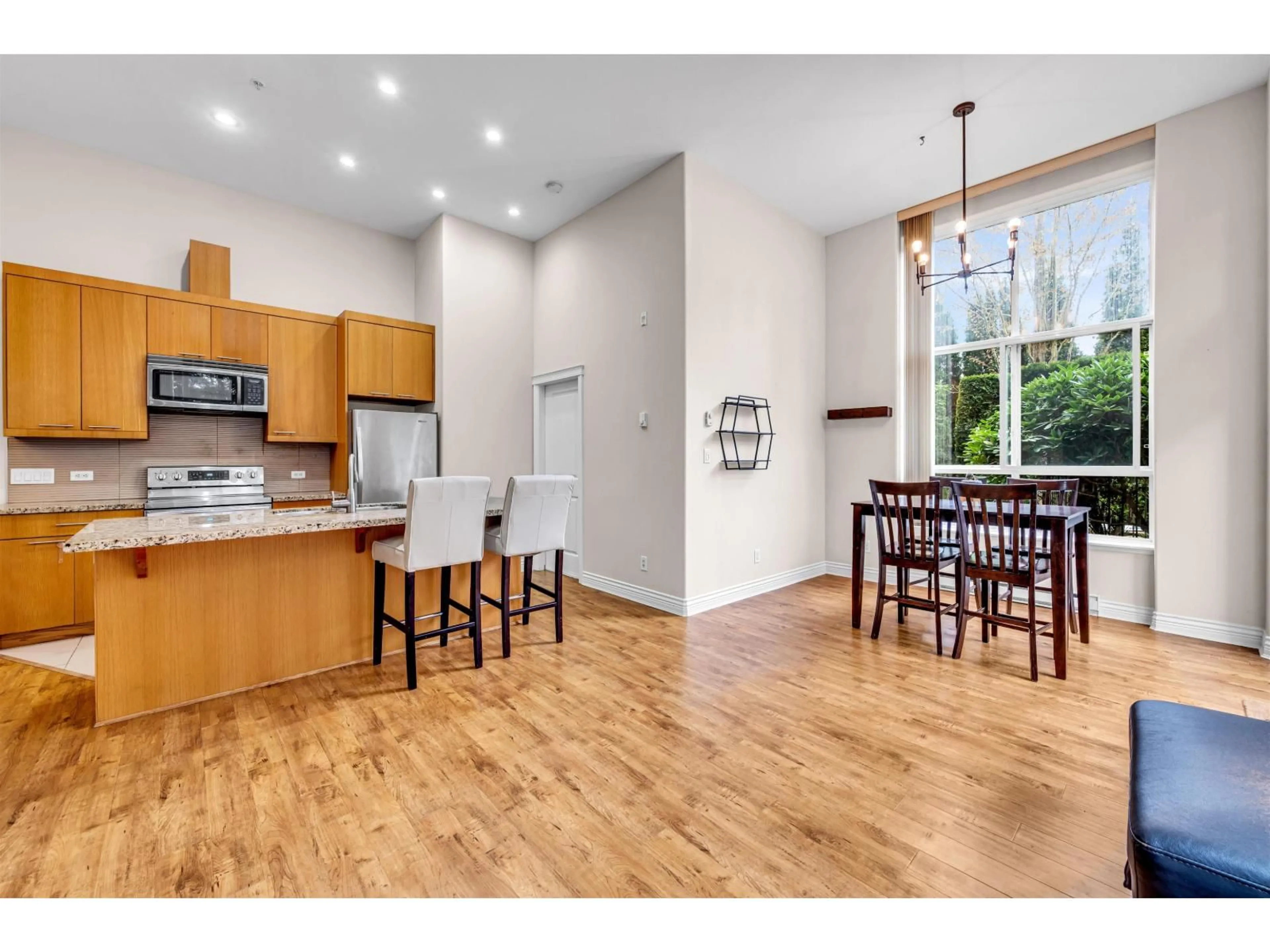 Open concept kitchen, wood/laminate floor for 111 - 2970 KING GEORGE BOULEVARD, Surrey British Columbia V4P0E6