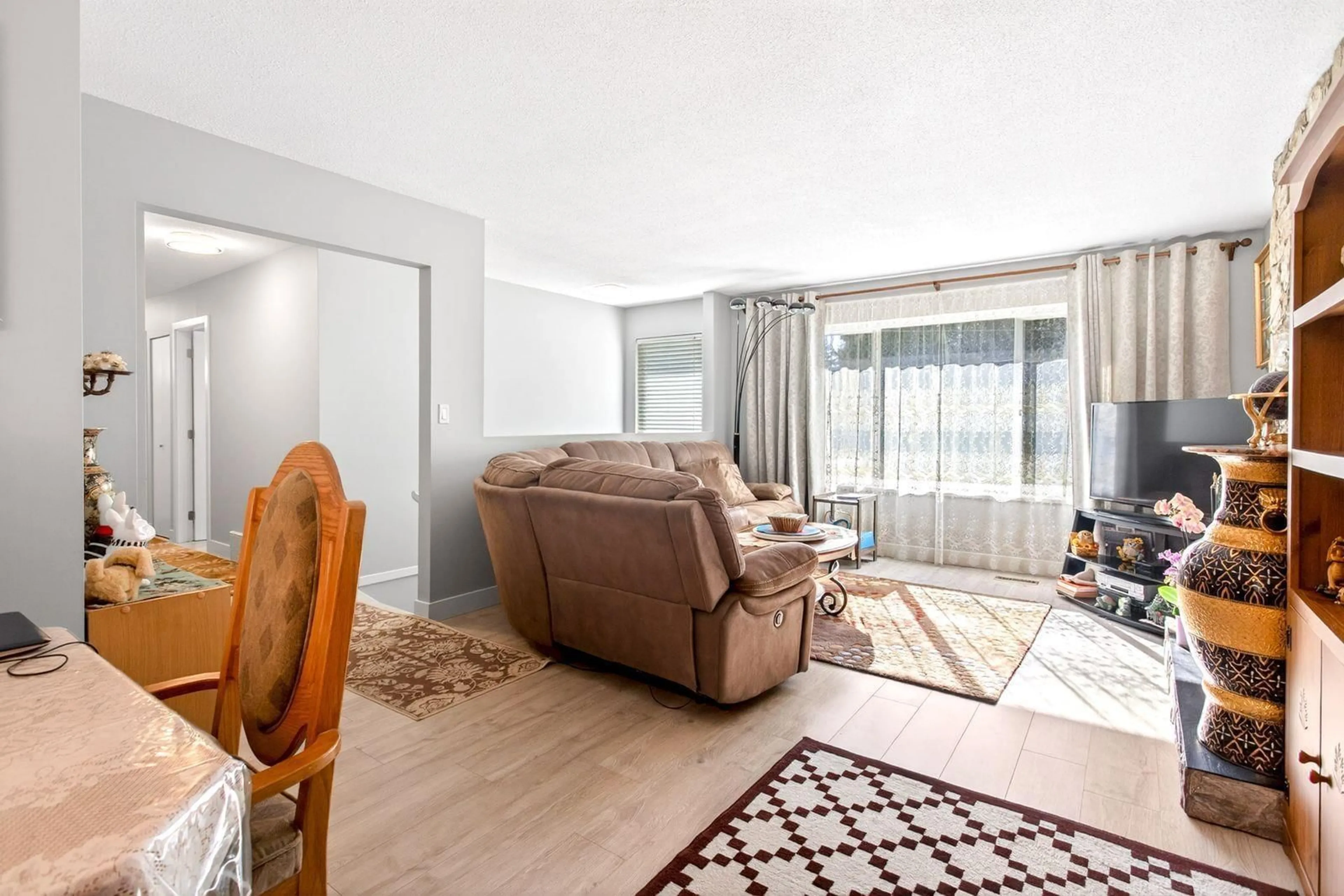 Living room with furniture, wood/laminate floor for 10842 144A STREET, Surrey British Columbia V3R3R1