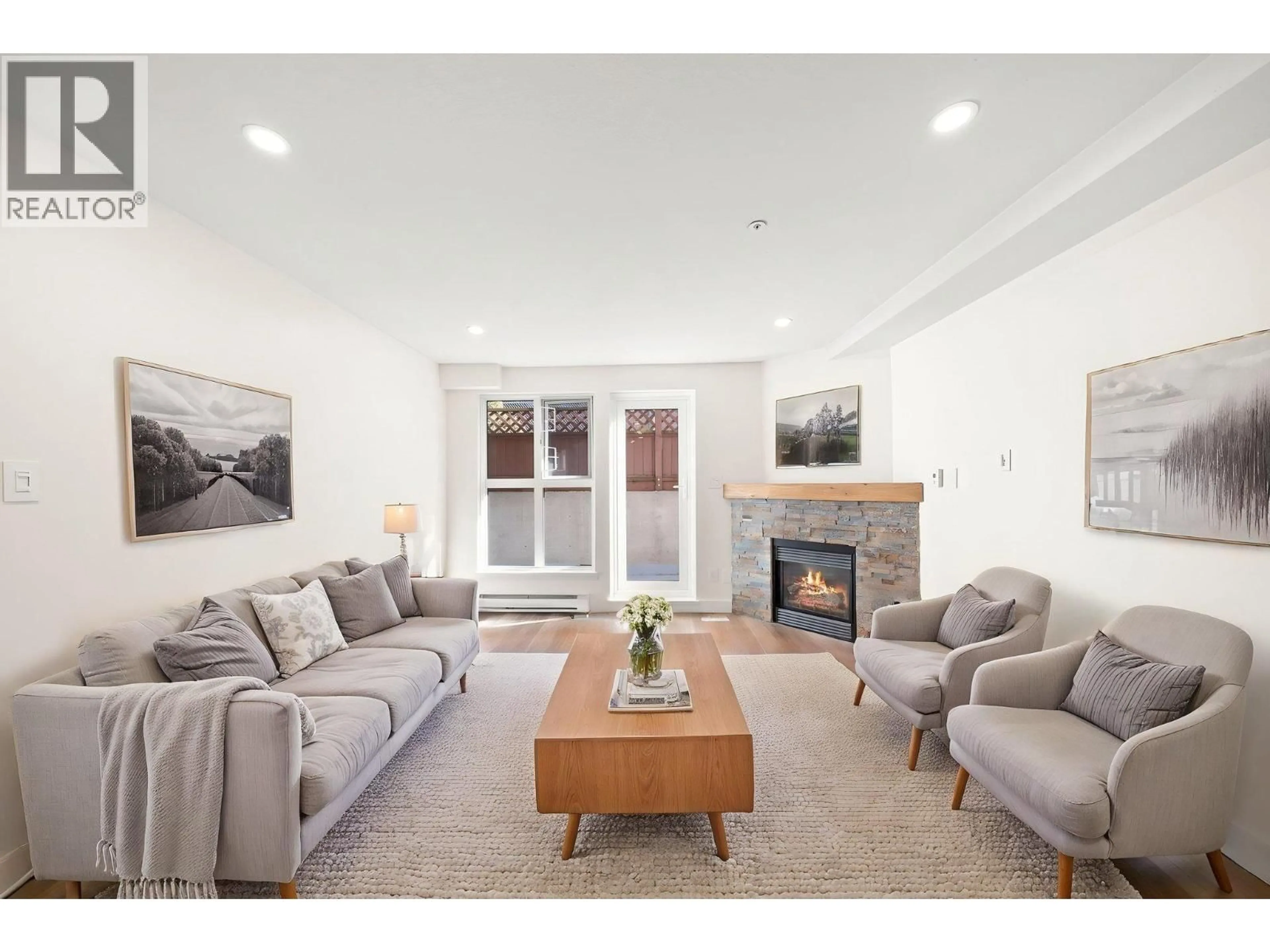 Living room with furniture, wood/laminate floor for 103 - 2212 OXFORD STREET, Vancouver British Columbia V5L1G1