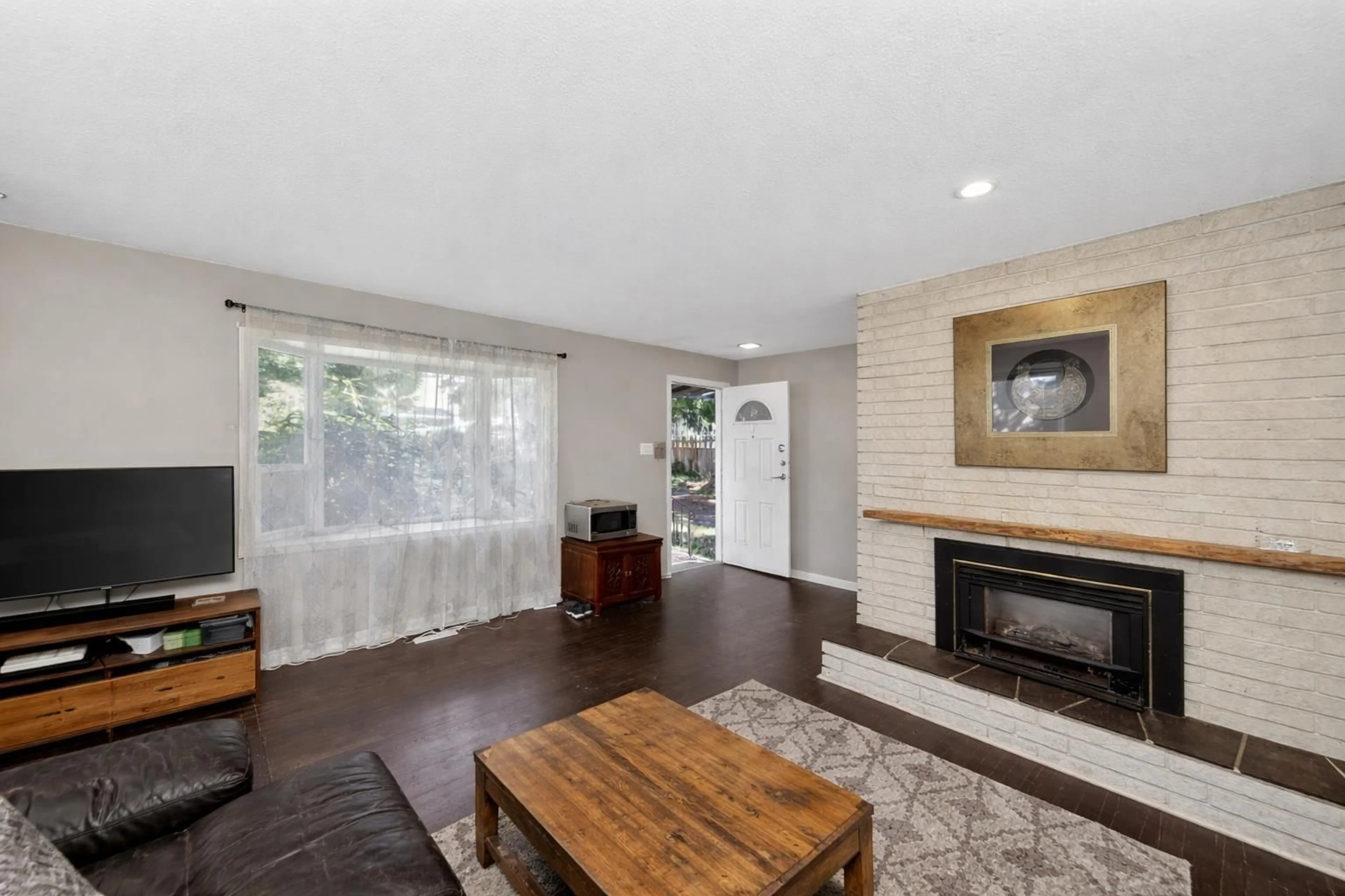 Living room with furniture, wood/laminate floor for 12564 25 AVENUE, Surrey British Columbia V4A2K3