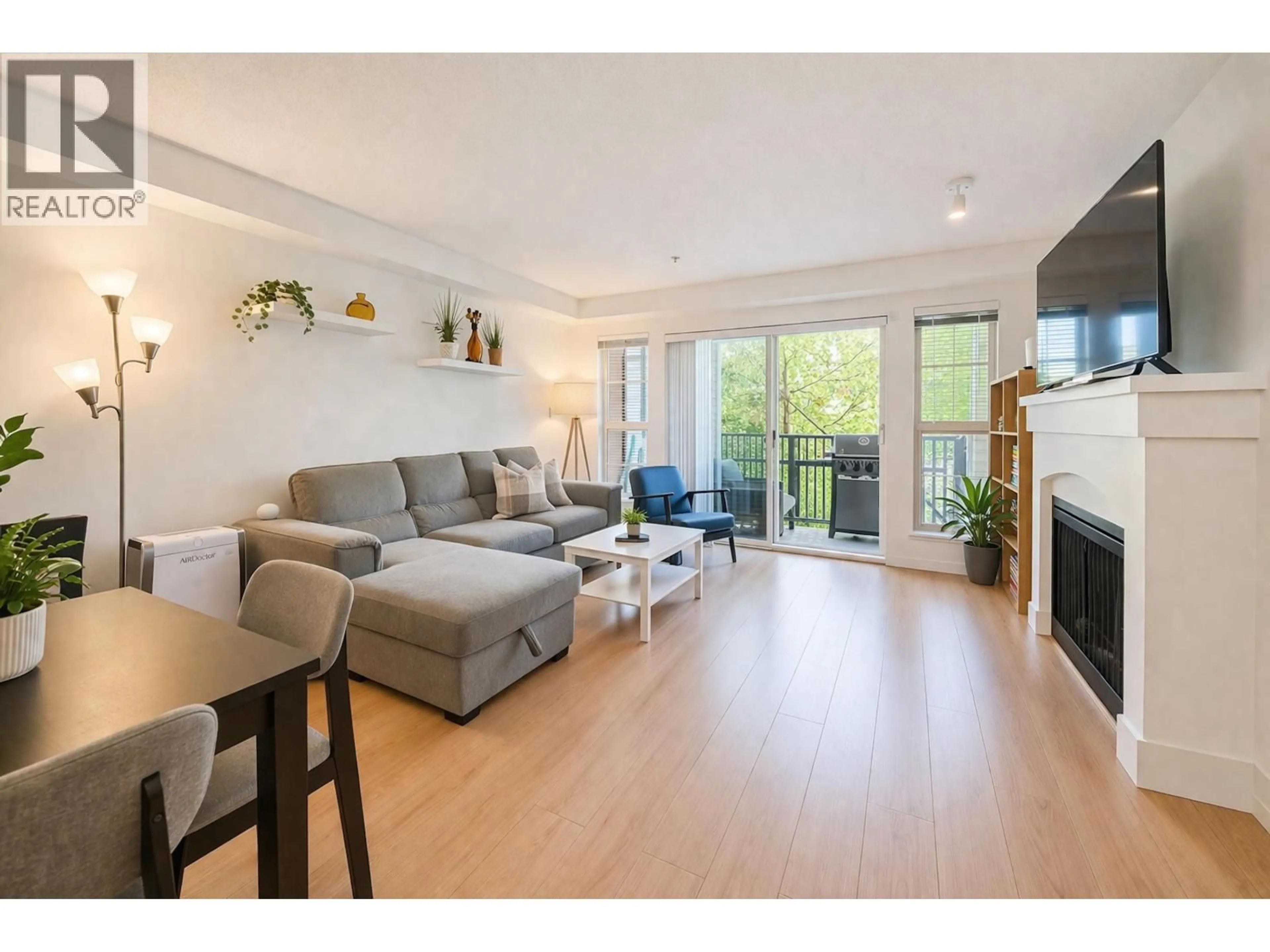 Living room with furniture, wood/laminate floor for 208 - 2958 SILVER SPRINGS BOULEVARD, Coquitlam British Columbia V3E3R9