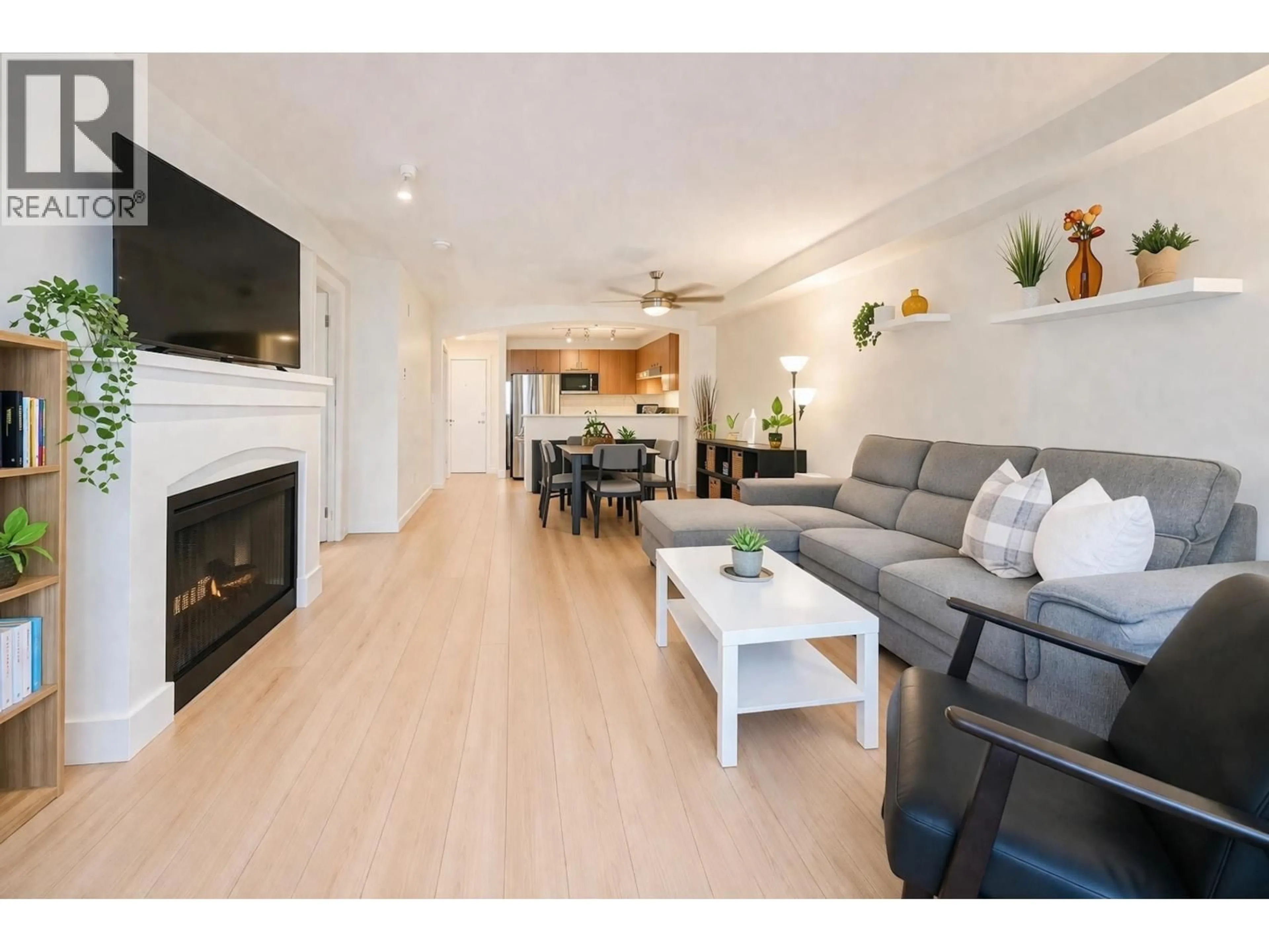 Living room with furniture, wood/laminate floor for 208 - 2958 SILVER SPRINGS BOULEVARD, Coquitlam British Columbia V3E3R9
