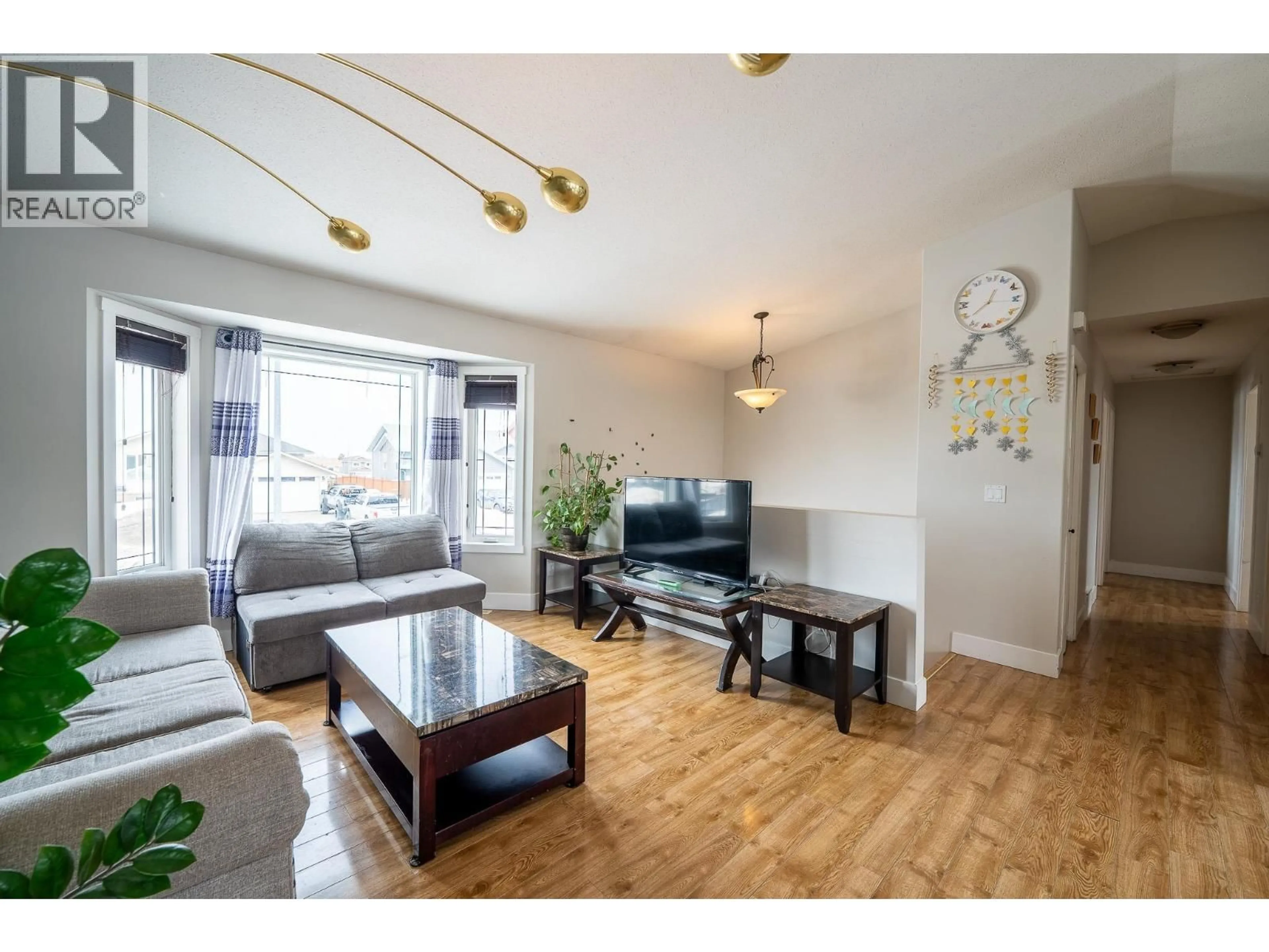 Living room with furniture, wood/laminate floor for 8727 113A AVENUE, Fort St. John British Columbia V1J0C4