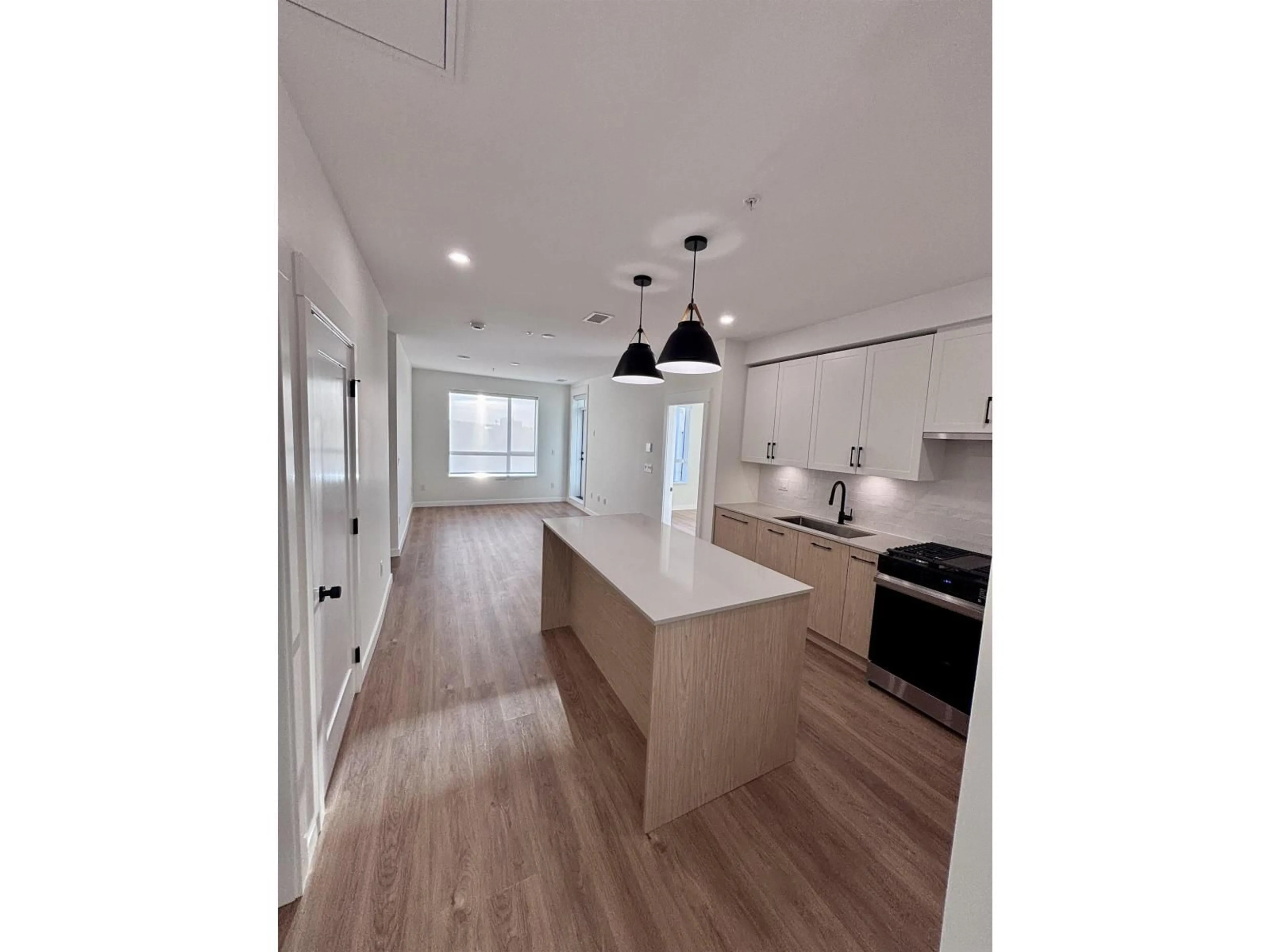 Open concept kitchen, wood/laminate floor for 711 - 27254 ALDERGROVE TOWN CENTRE DRIVE, Langley British Columbia V4W0E5