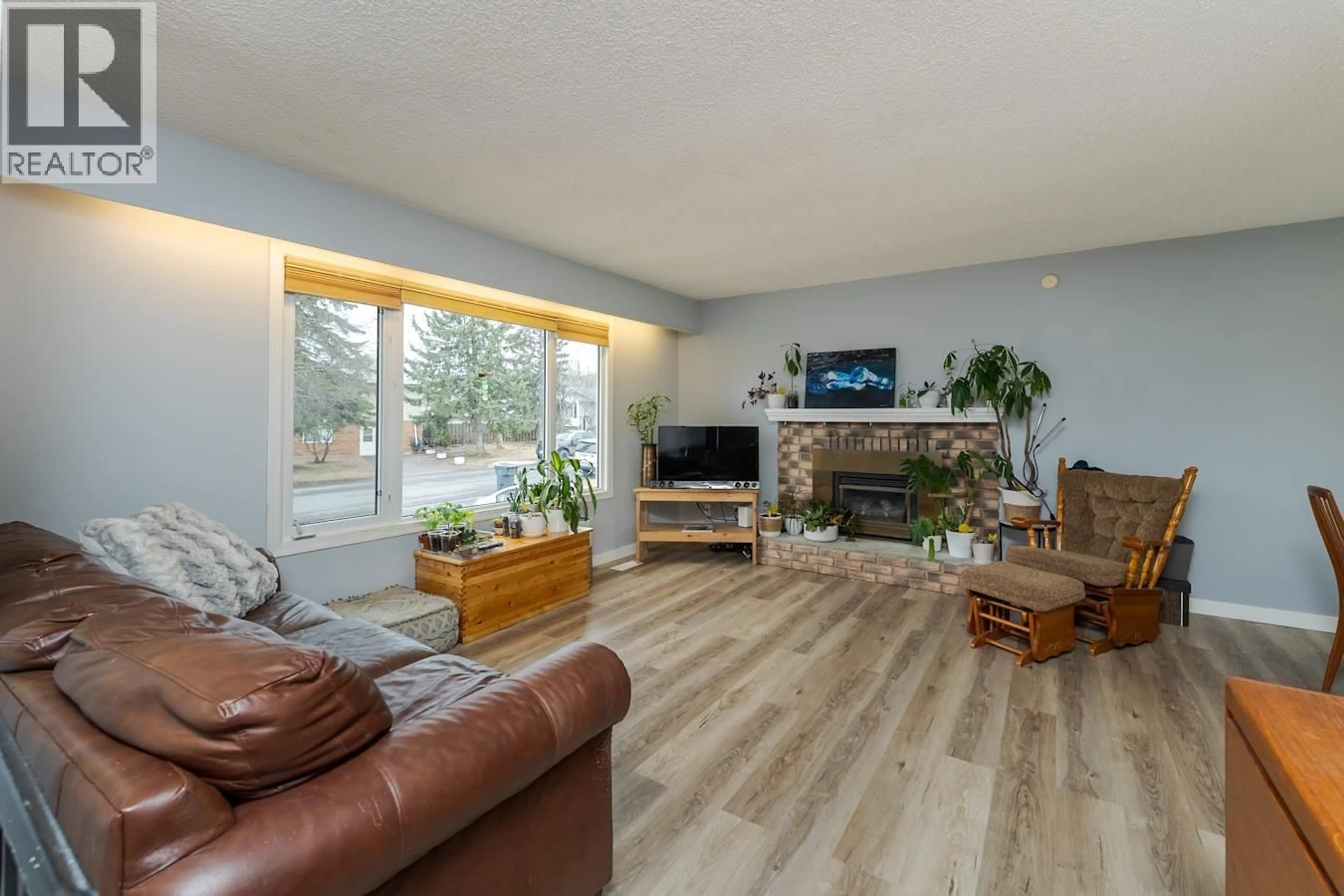Living room with furniture, wood/laminate floor for 234 EXPLORER CRESCENT, Prince George British Columbia V2M5R8