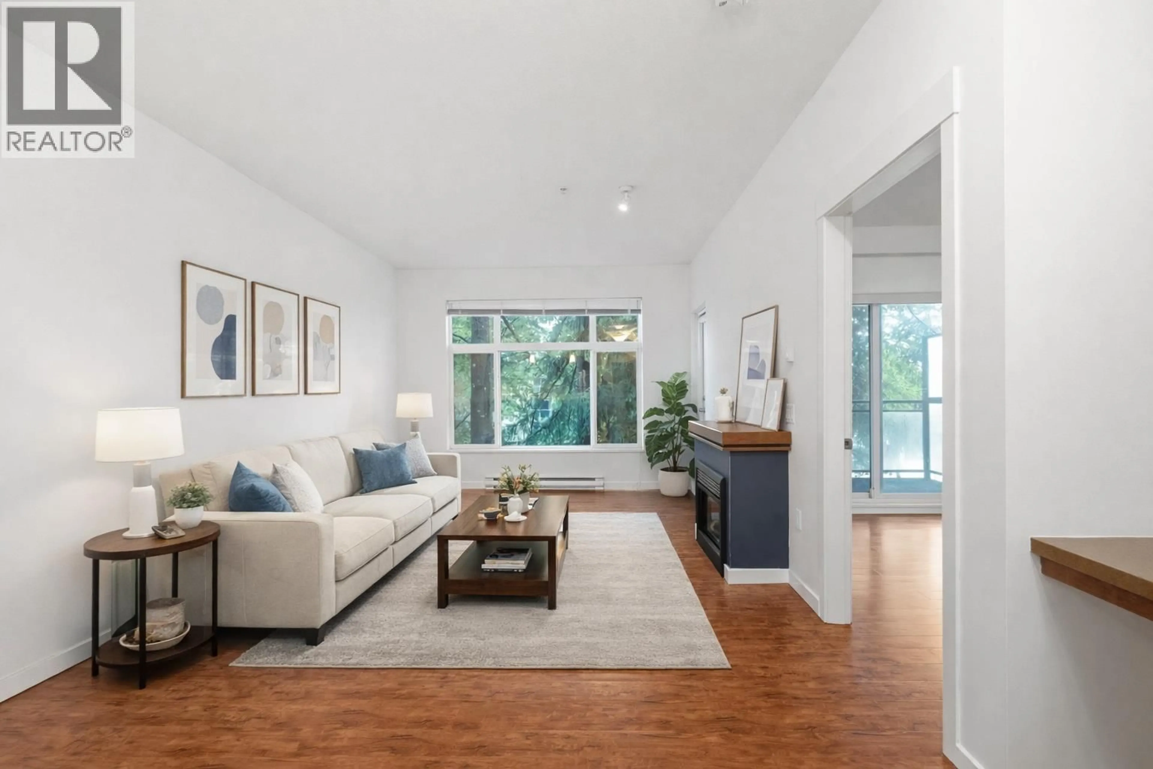 Living room with furniture, wood/laminate floor for 309 - 11950 HARRIS ROAD, Pitt Meadows British Columbia V3Y0B7
