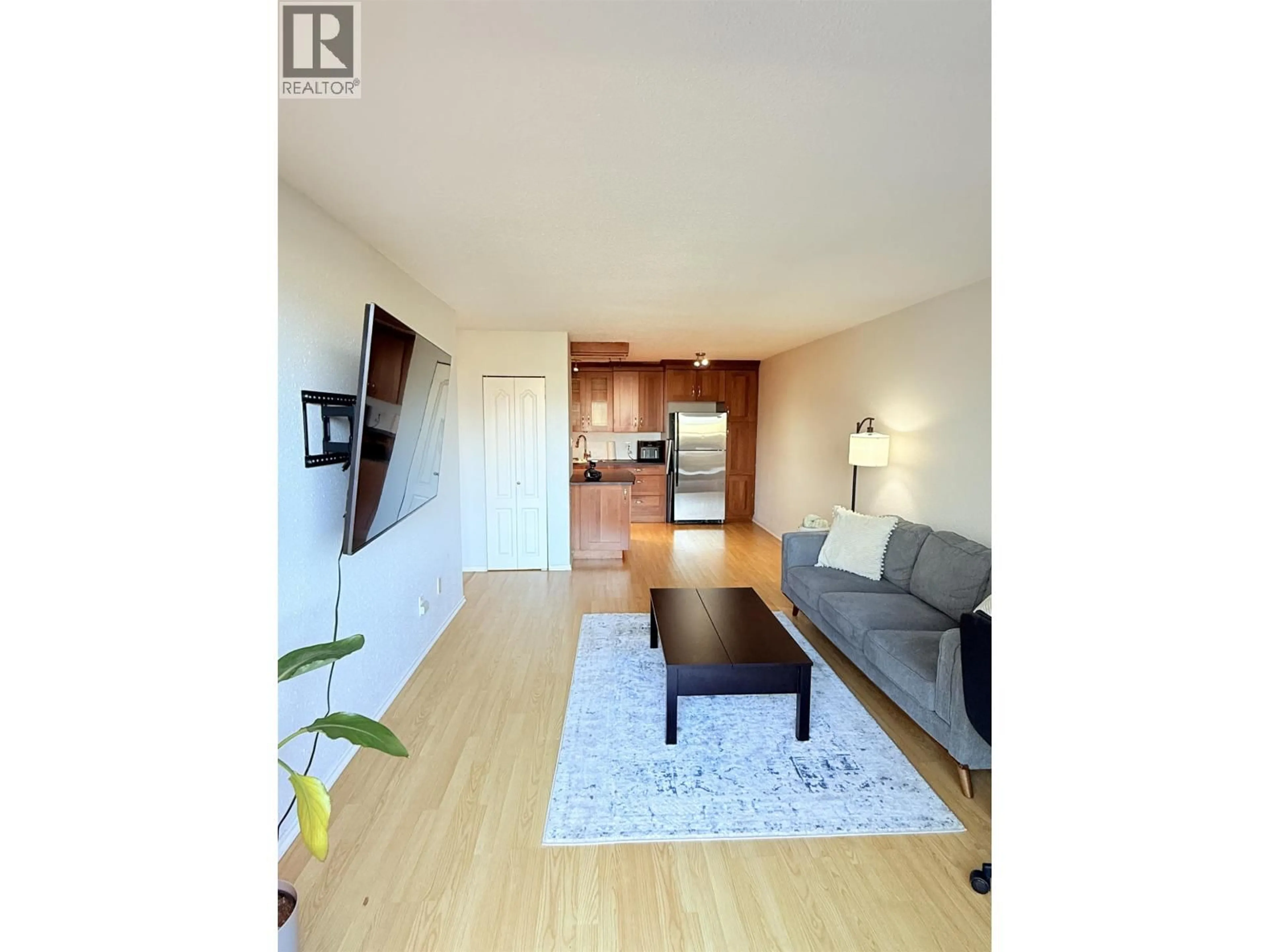 Living room with furniture, wood/laminate floor for 615 - 774 GREAT NORTHERN WAY, Vancouver British Columbia V5T1E5