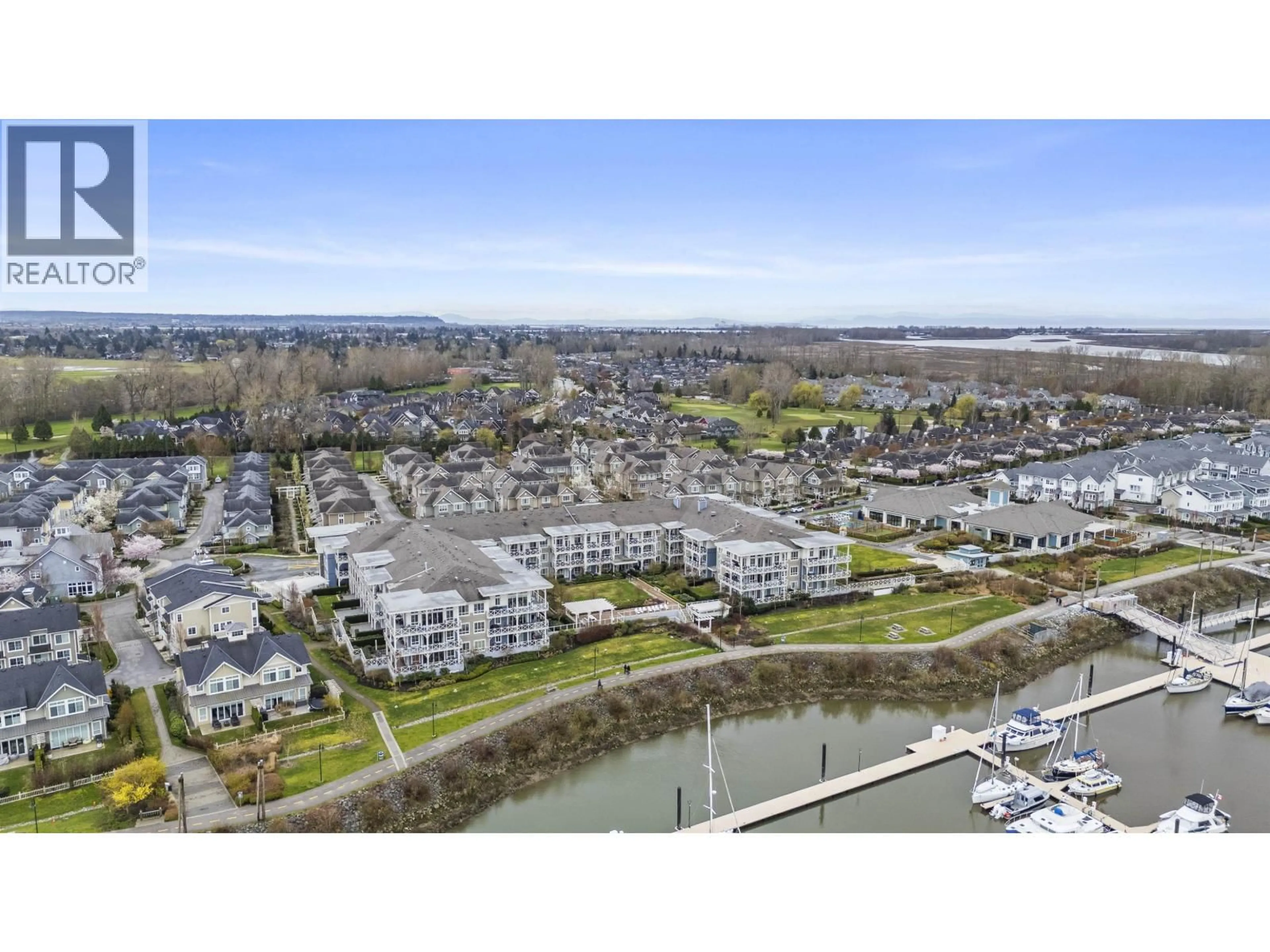 A pic from outside/outdoor area/front of a property/back of a property/a pic from drone, water/lake/river/ocean view for 220 - 5535 ADMIRAL WAY, Ladner British Columbia V4K0E3