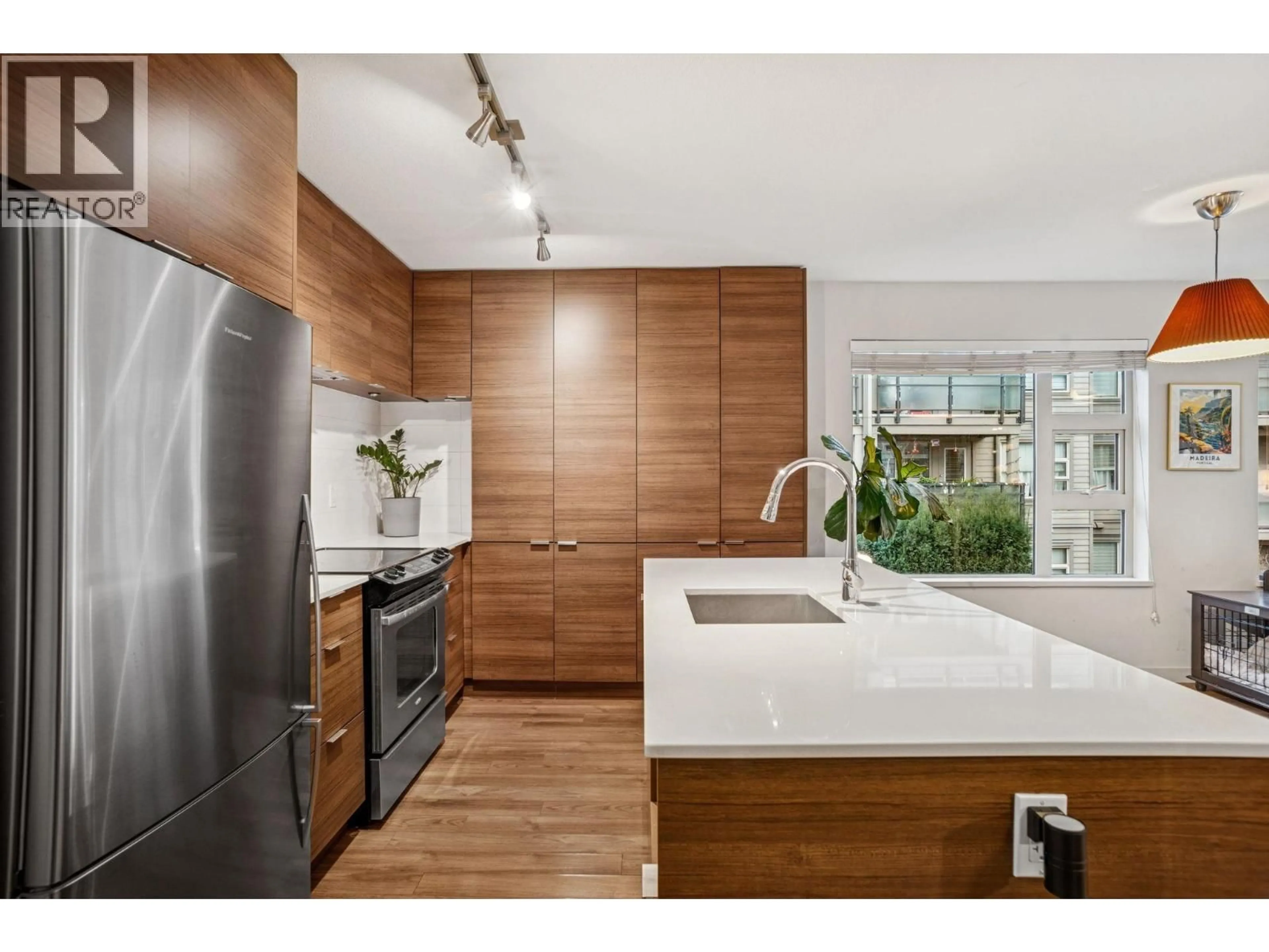 Open concept kitchen, wood/laminate floor for 310 - 1673 LLOYD AVENUE, North Vancouver British Columbia V7P0A9